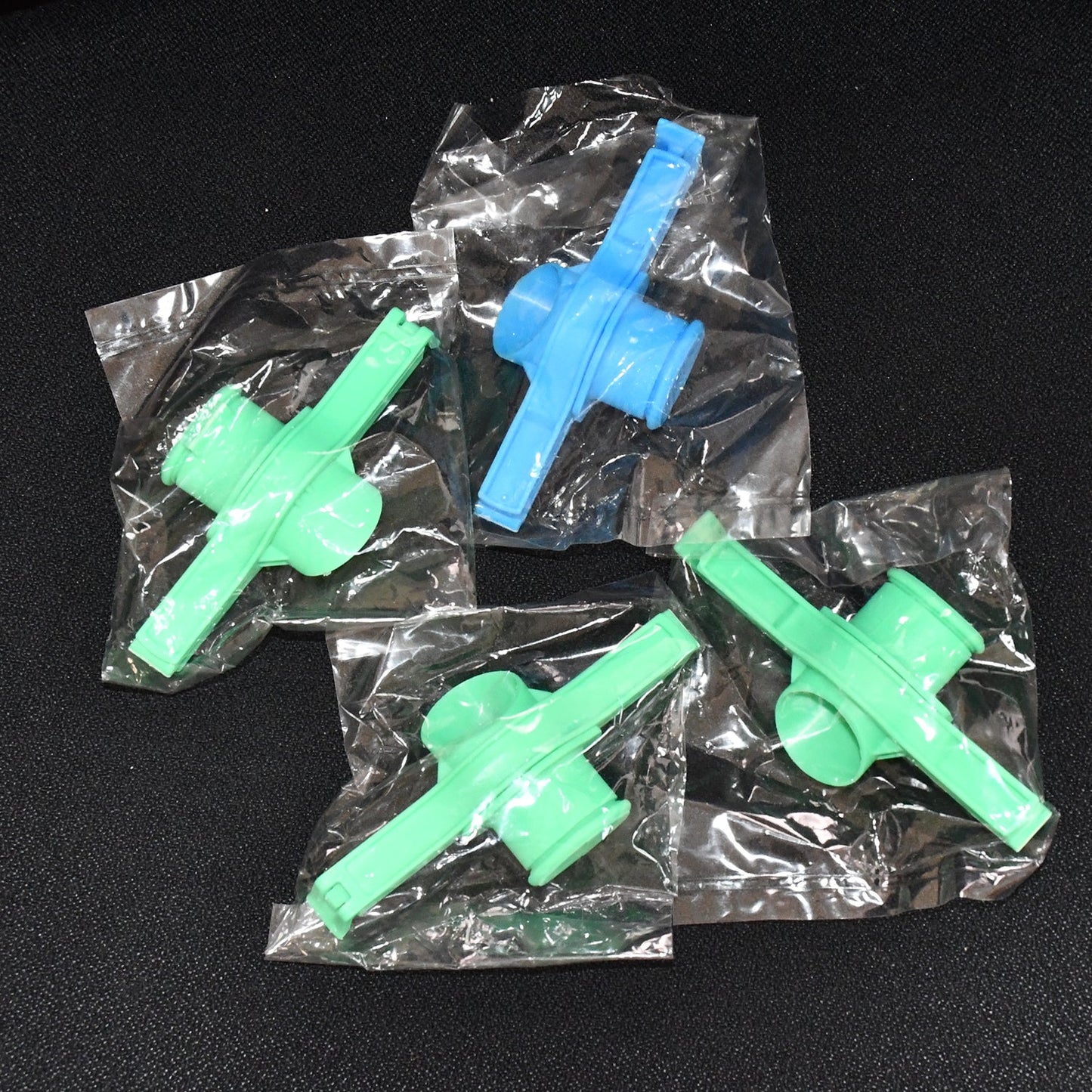 Multiple Food Pouch Sealer Clips in various colours on a kitchen counter.