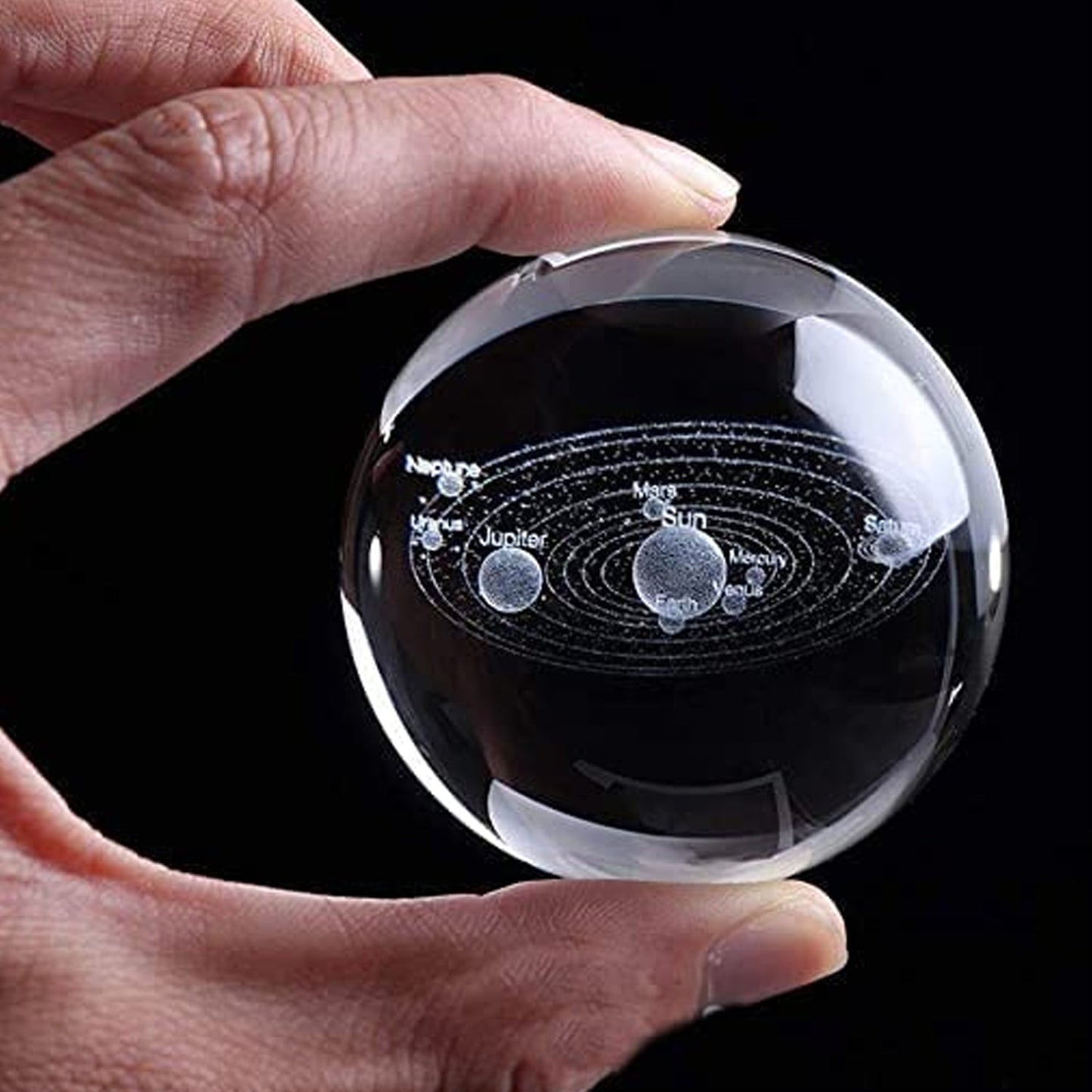 Decorative astronomy crystal ball lamp displayed on a modern desk.