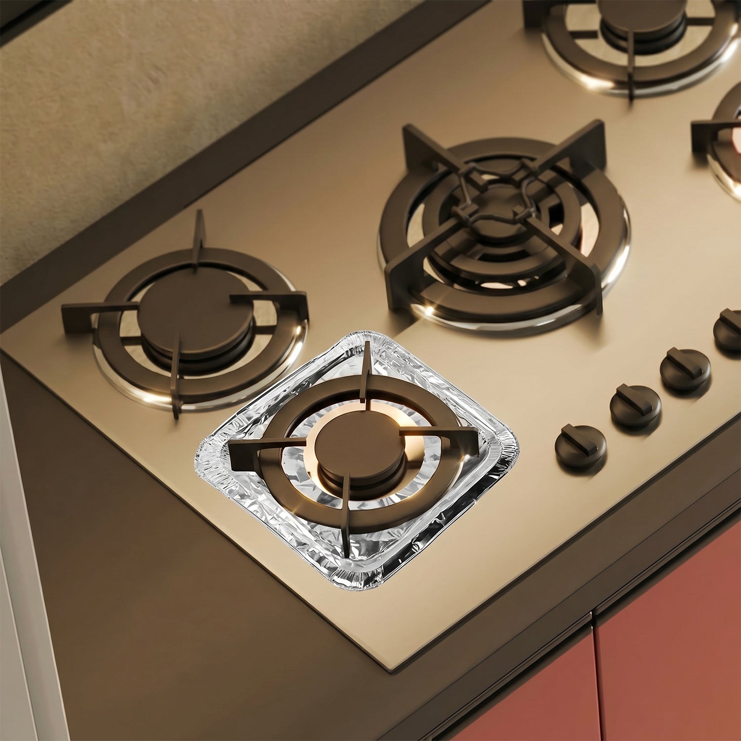 Gas stove with aluminium foil cover protecting burner area
