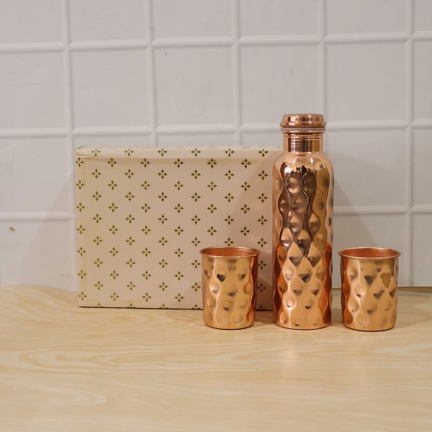Group shot of the copper water bottle and two glasses, emphasizing the full set.