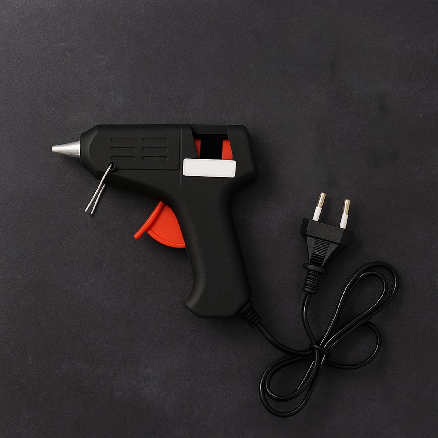 Angled view of 20W hot melt glue gun showing power cord and trigger-feed mechanism