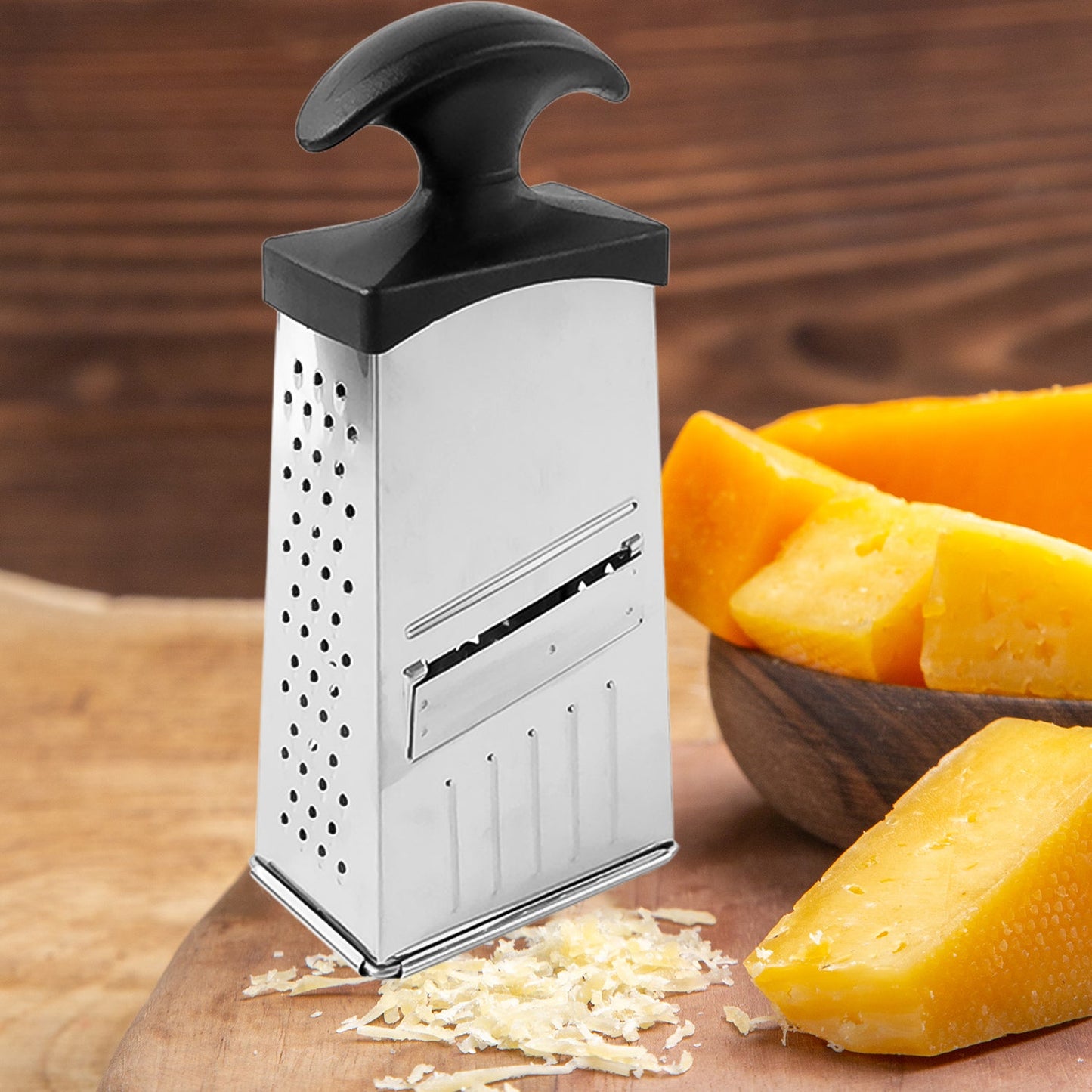 Compact stainless steel grater and slicer with non-slip handle base