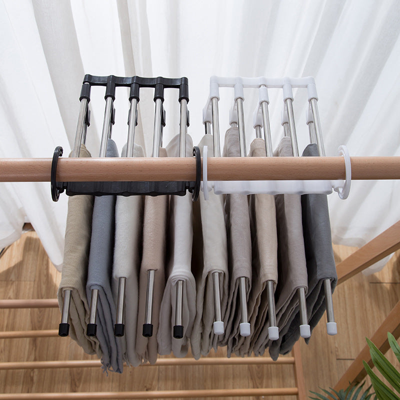 Organivo space-saving hanger with adjustable arms, demonstrating ease of use for trousers.