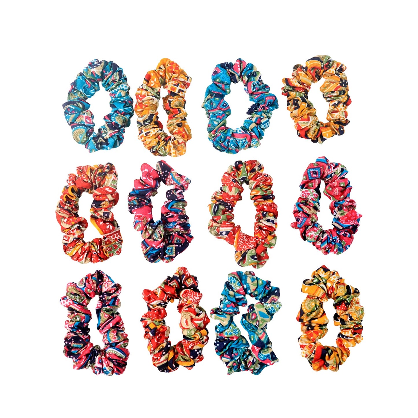 Displayed set of 12 printed fabric hair scrunchies on a flat surface