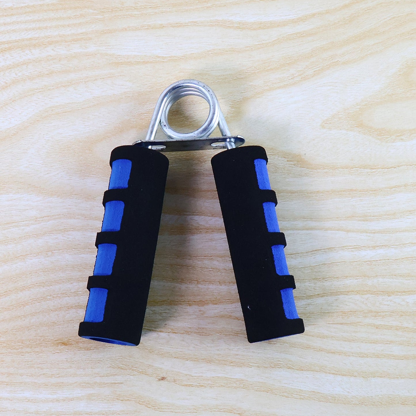 Hand grip exerciser showing foam padded ergonomic handles