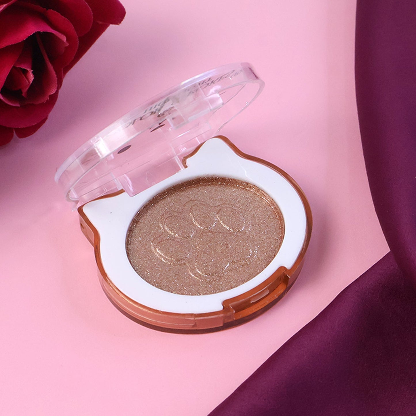Shimmer highlighter compact open showing the powder surface