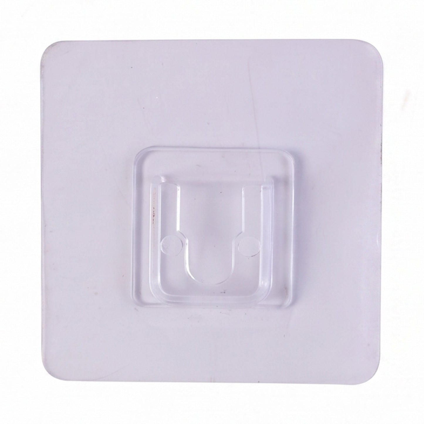Transparent wall hook attached to a smooth surface for organization.