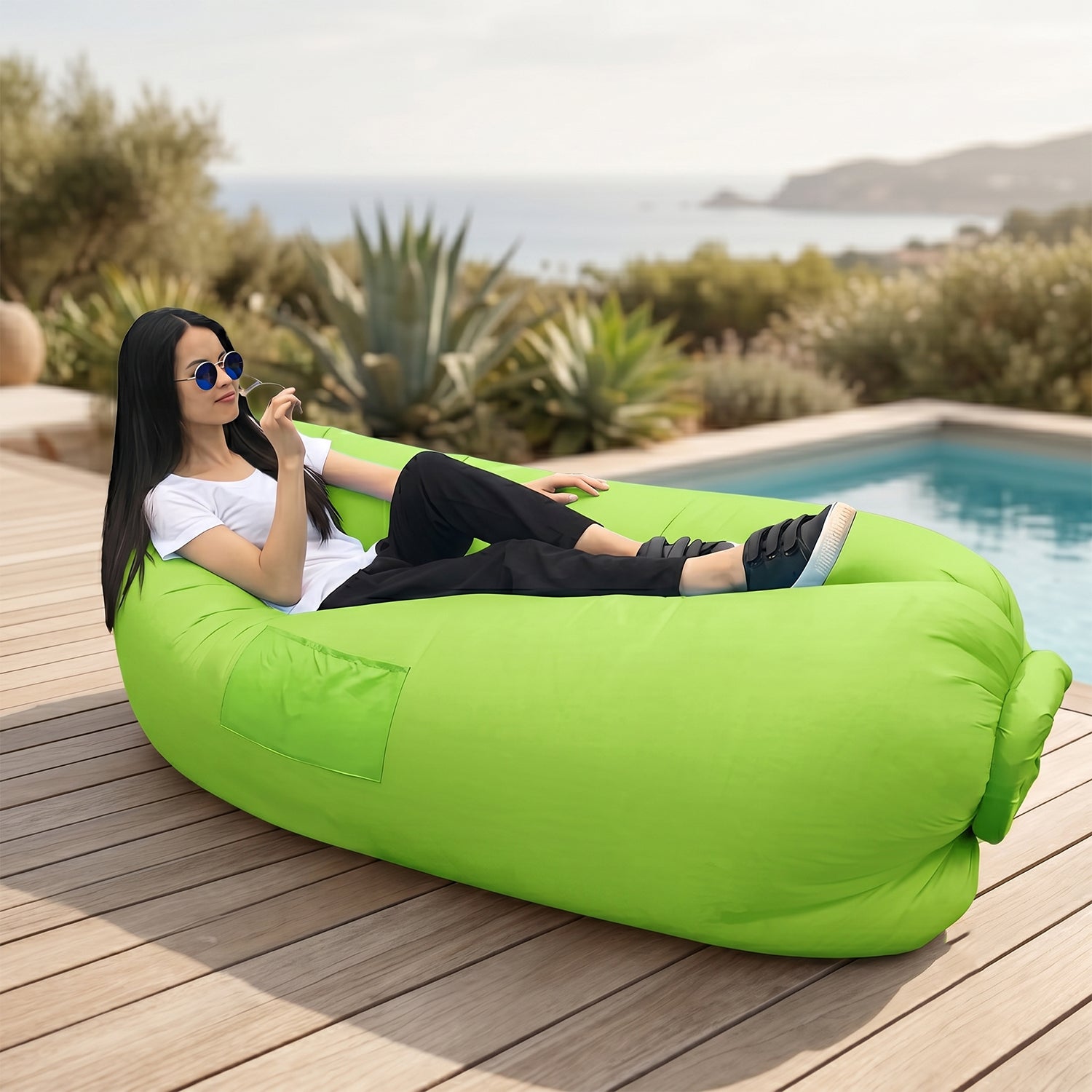 Pink inflatable air lounger on green grass