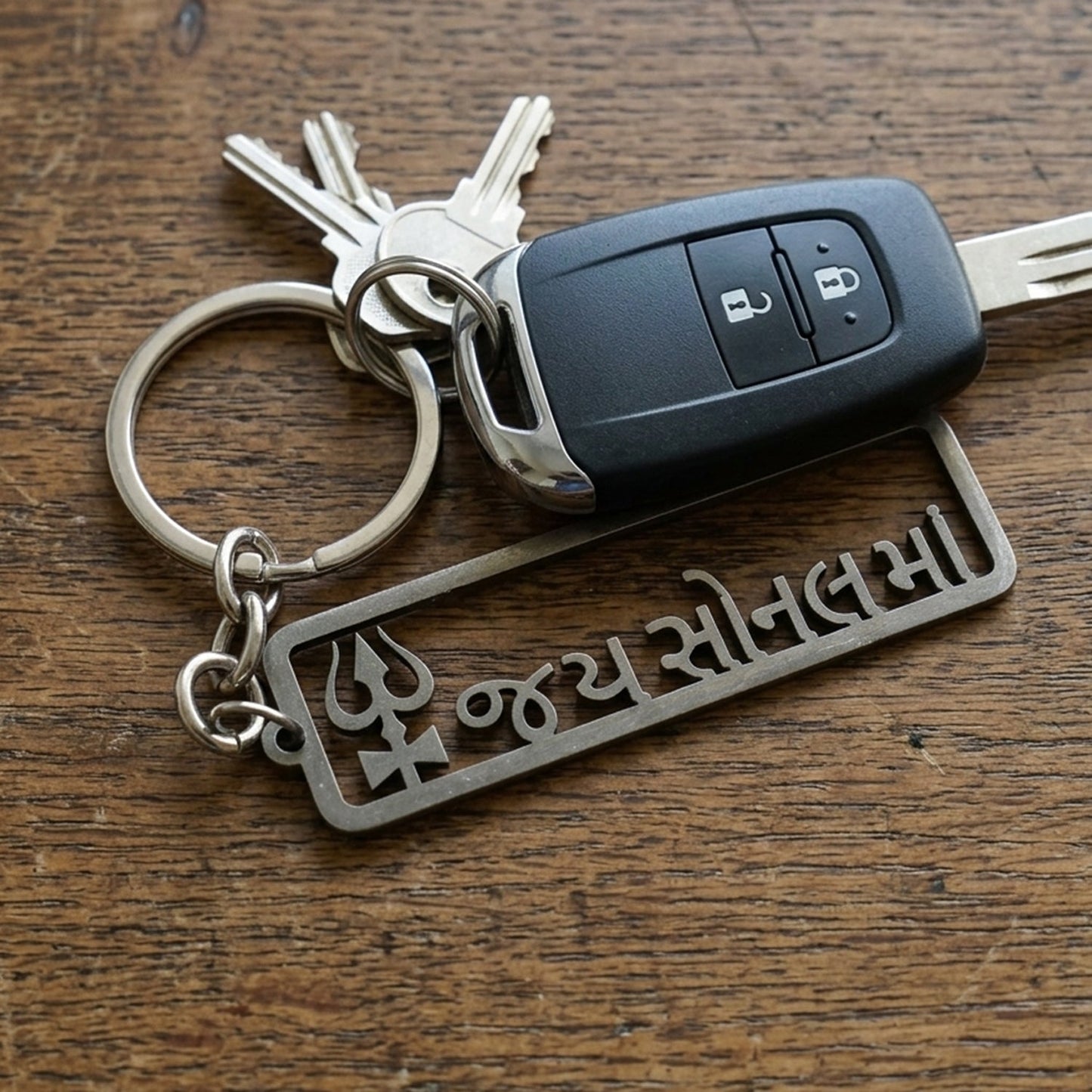 Rectangle-shaped Trishul design keychain in metallic finish