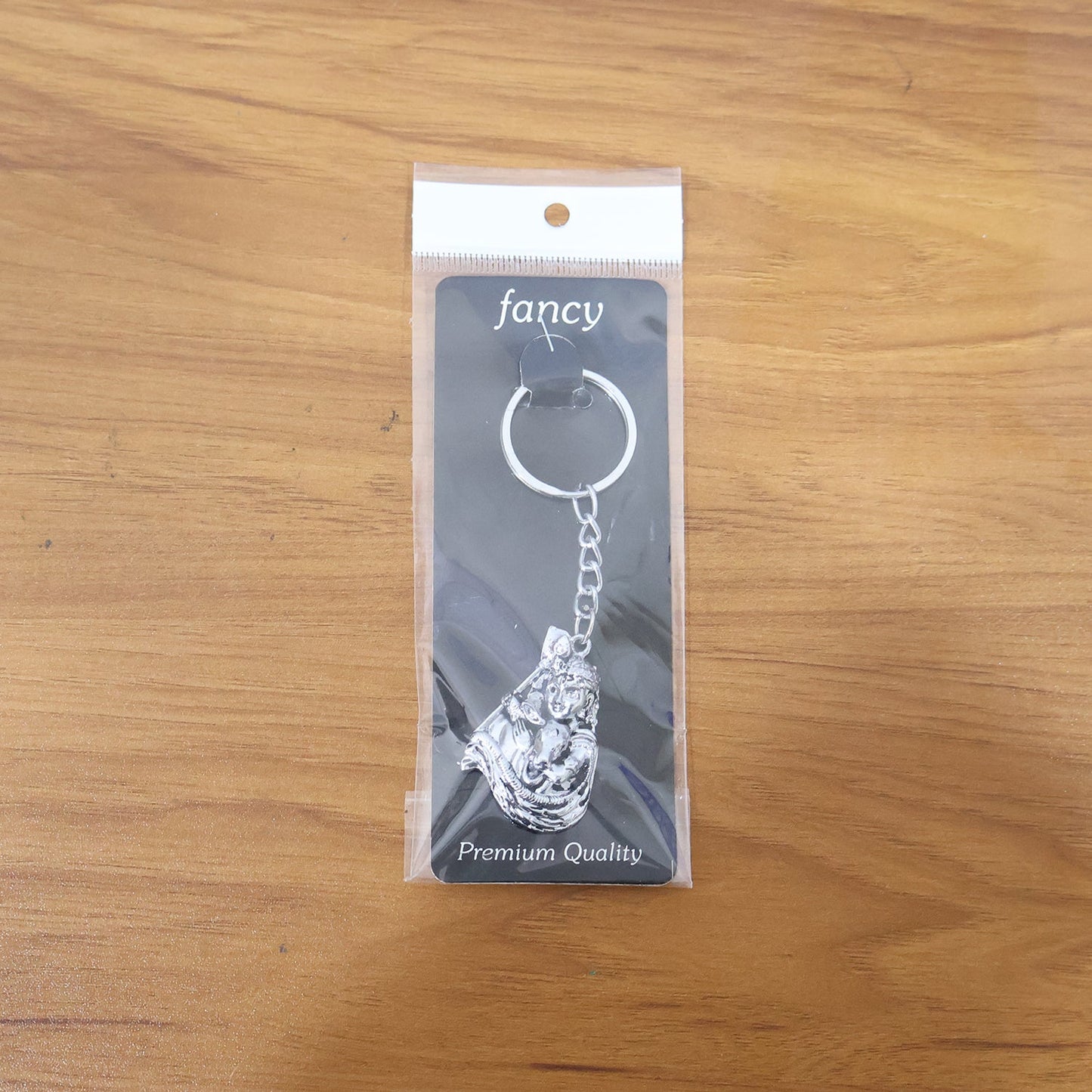 Lifestyle image of silver finish Bal Krishna keychain attached to car keys