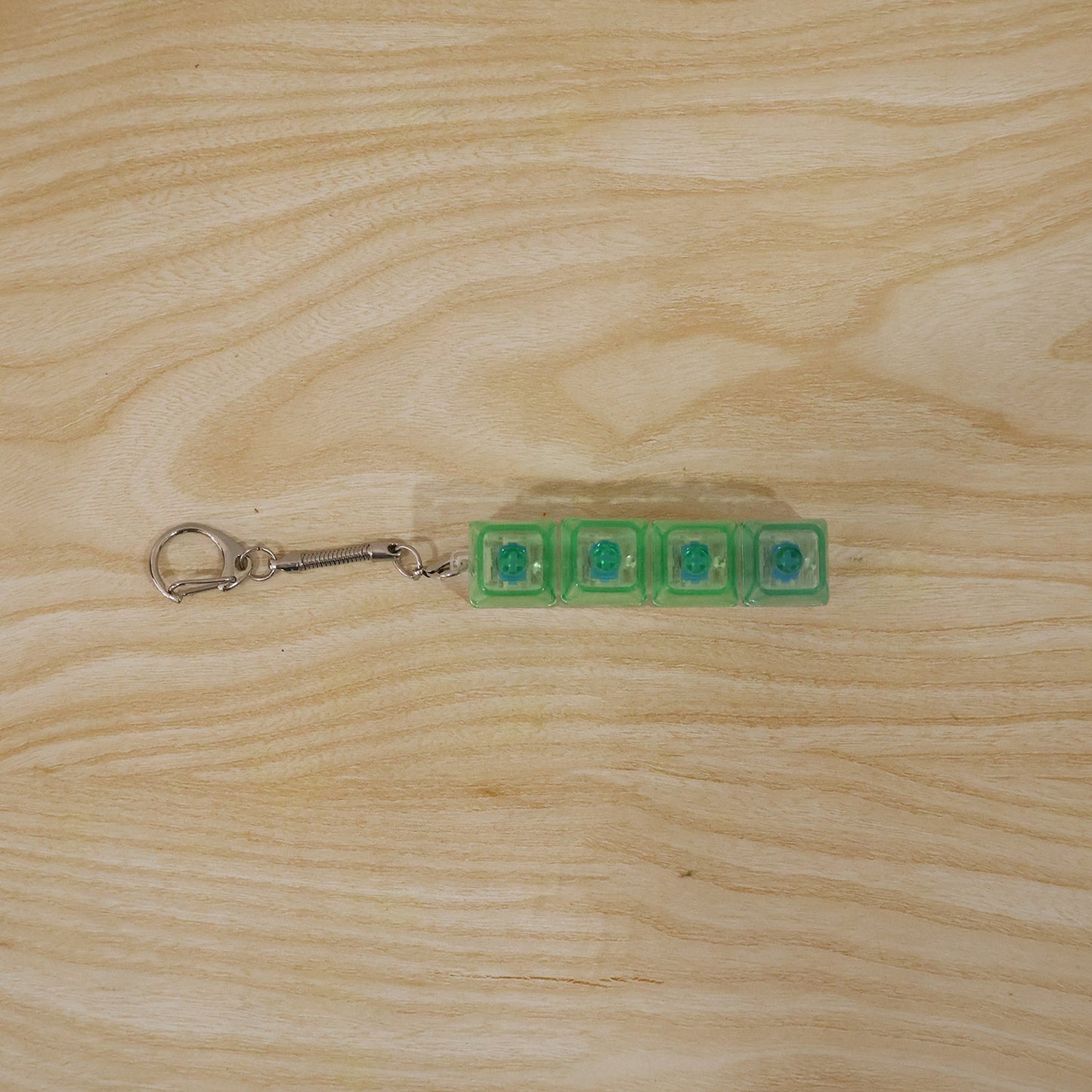 Small gadget key holder with tactile click and LED glow