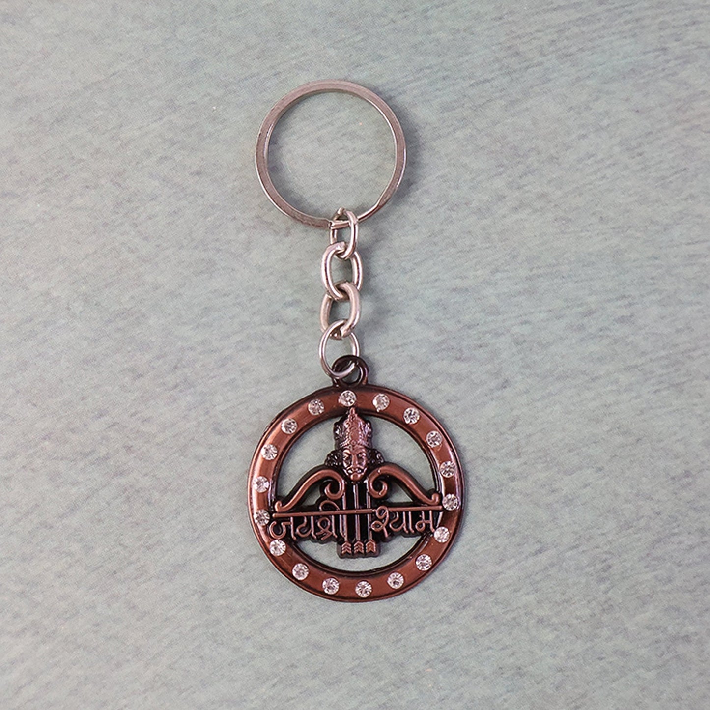 Metal Jai Shree Shyam keychain displaying intricate engraving and crystals