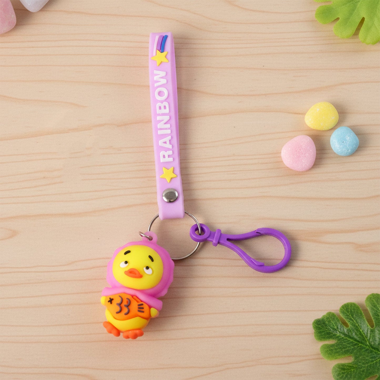 Cartoon duck key ring showing duck holding fish on rainbow strap