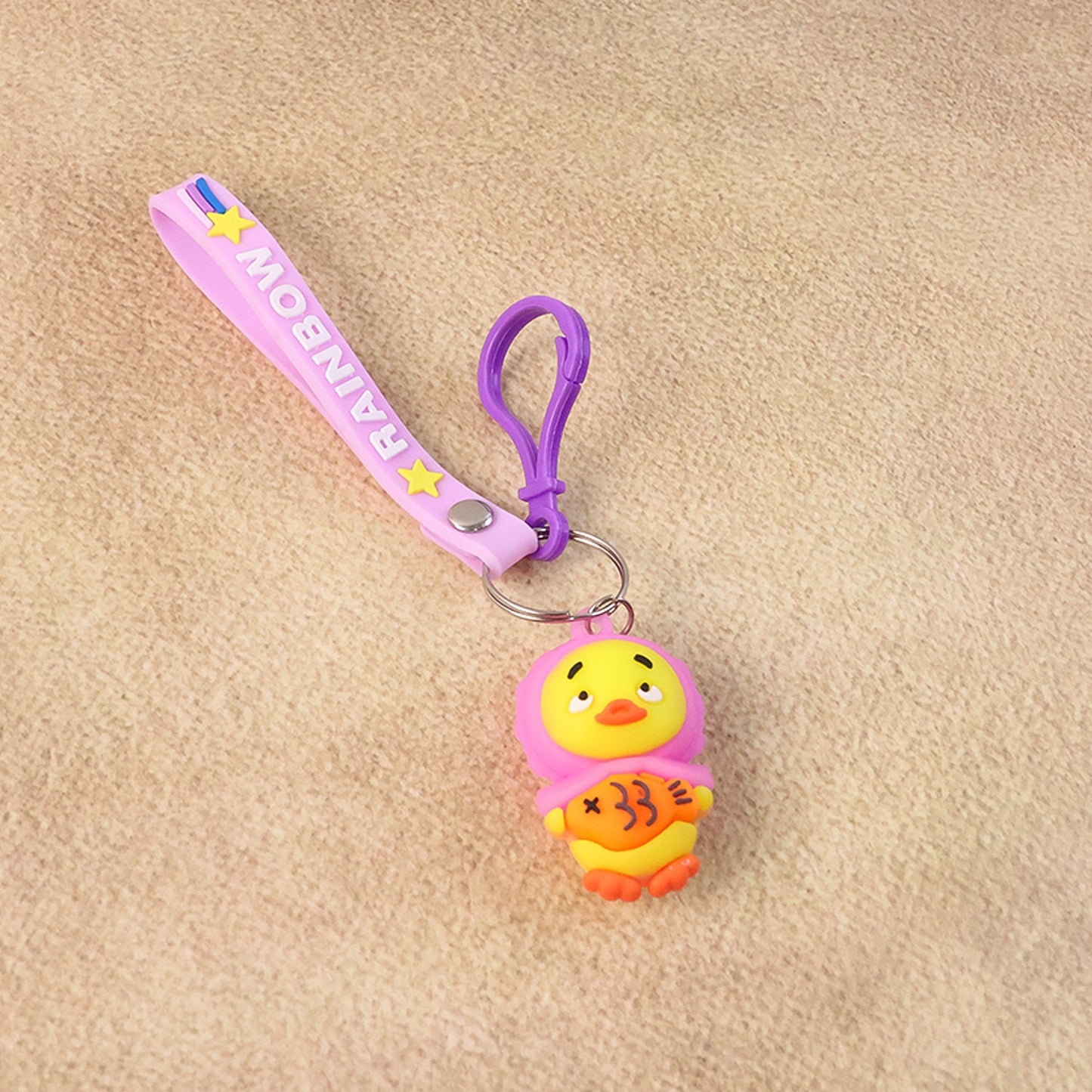 Soft rubber duck figure keychain with vibrant rainbow-themed strap