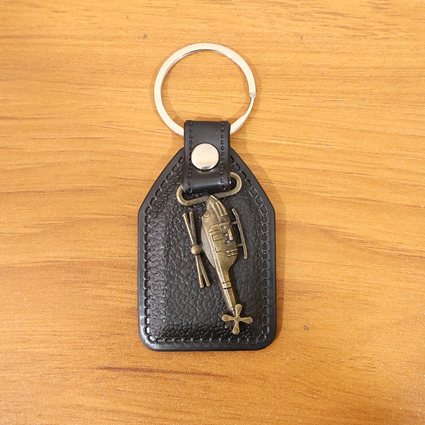 Full display of stylish leather and metal sword emblem keychain