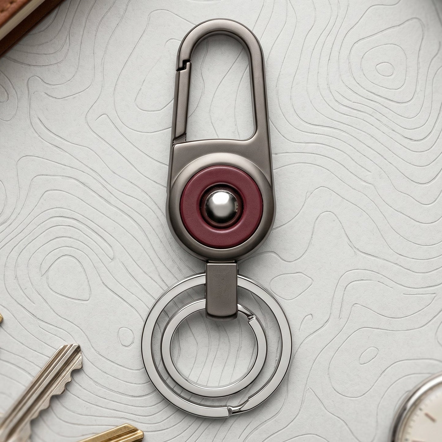 Durable metal key holder with dual rings and locking clip attached to a backpack