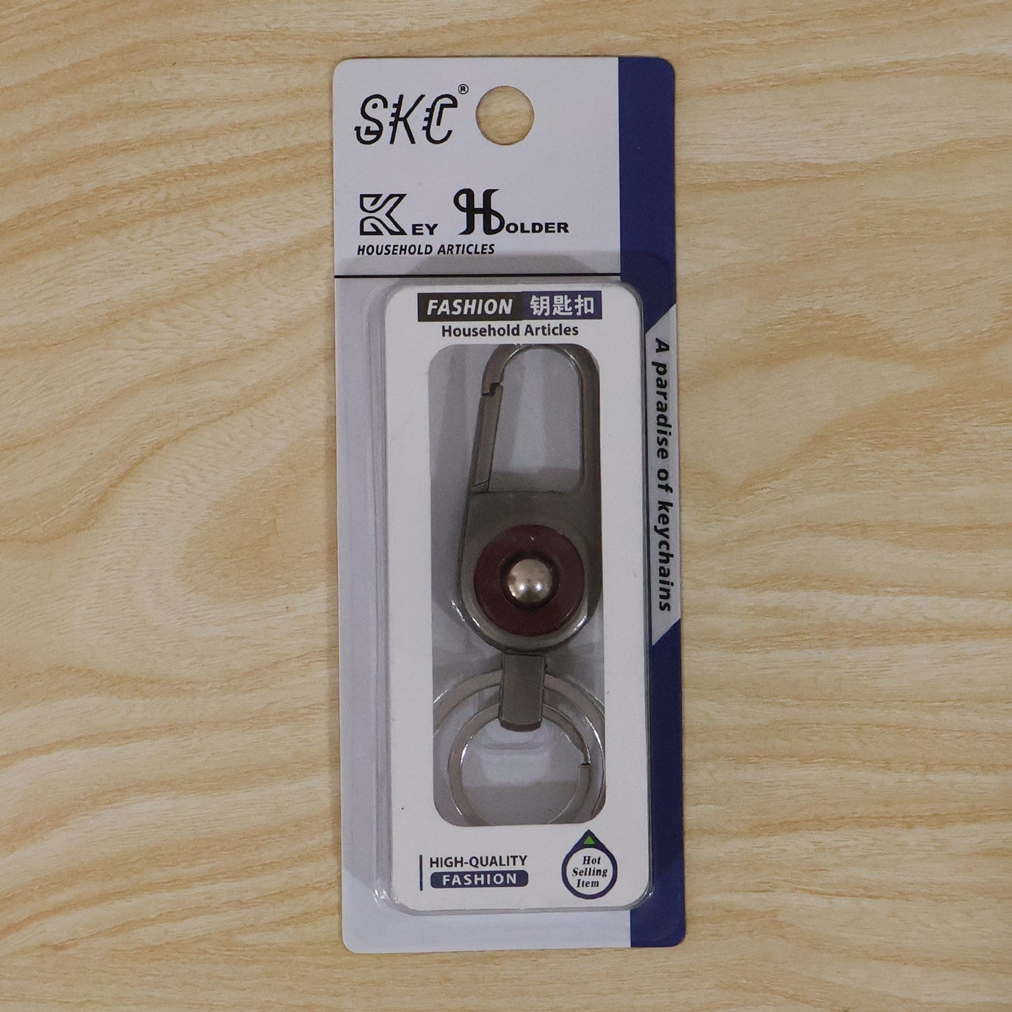 Compact metal key holder featuring locking carabiner clip in outdoor setting