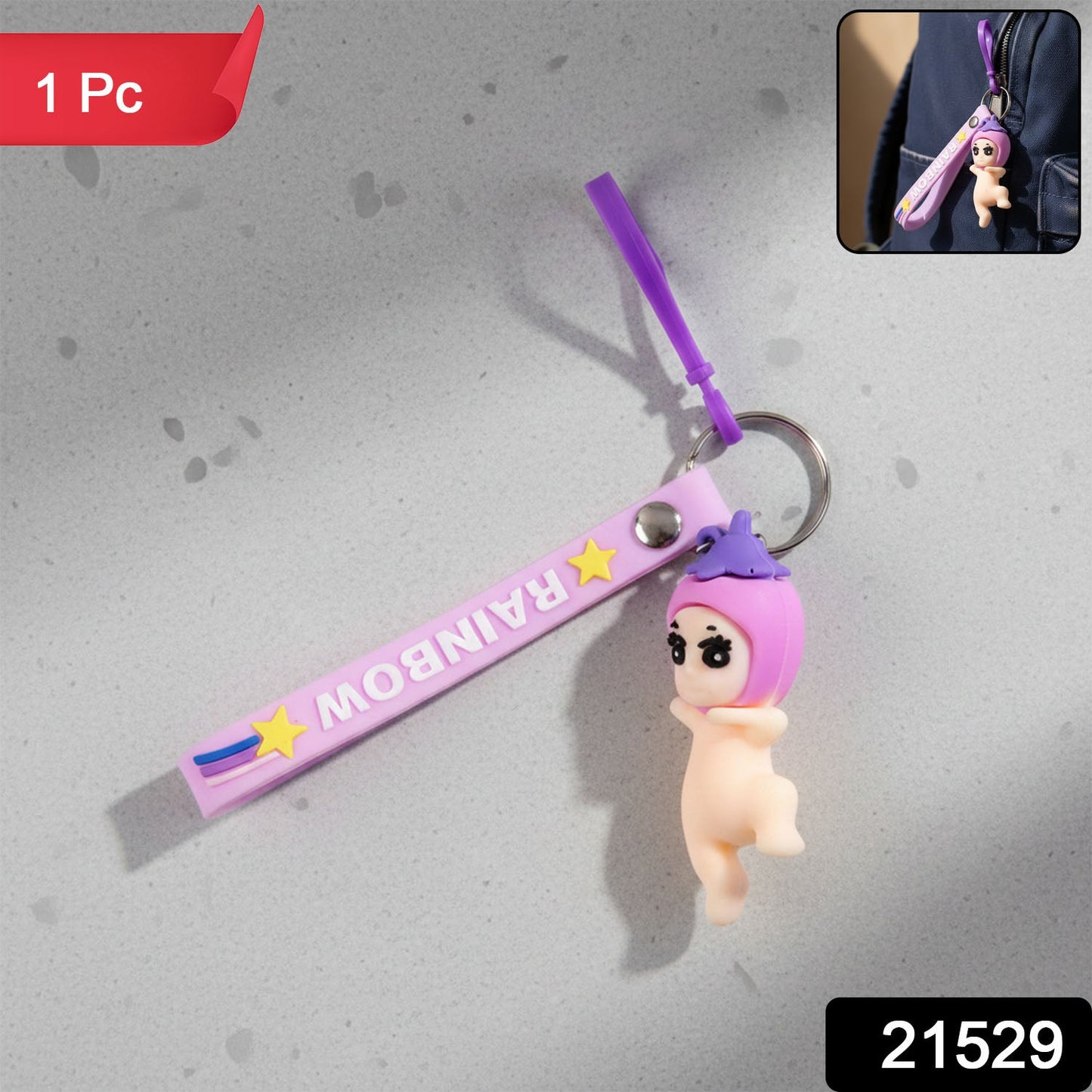 Decorative baby doll silicone keychain hanging from a bag strap