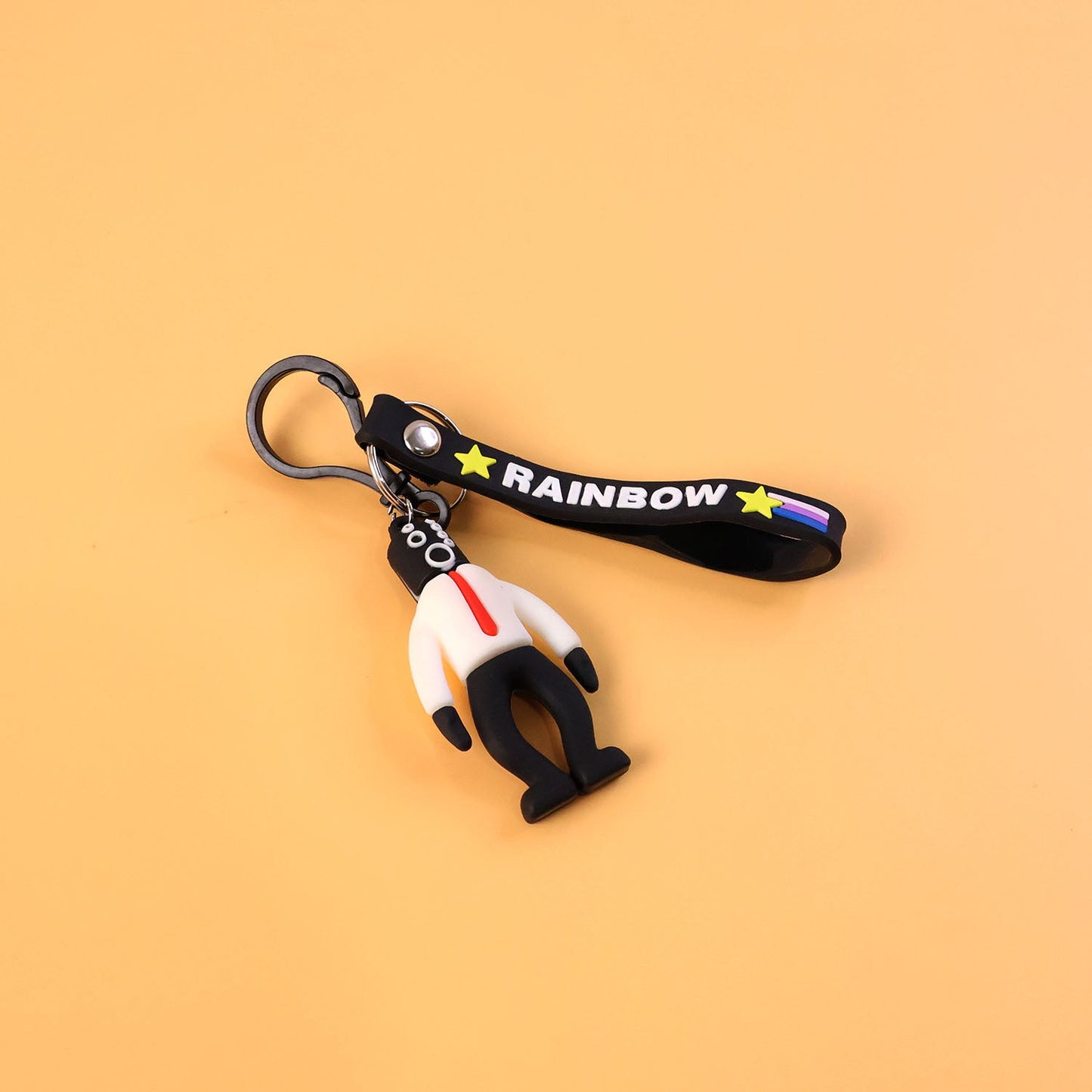 Detailed view of rainbow strap on cartoon man keychain accessory