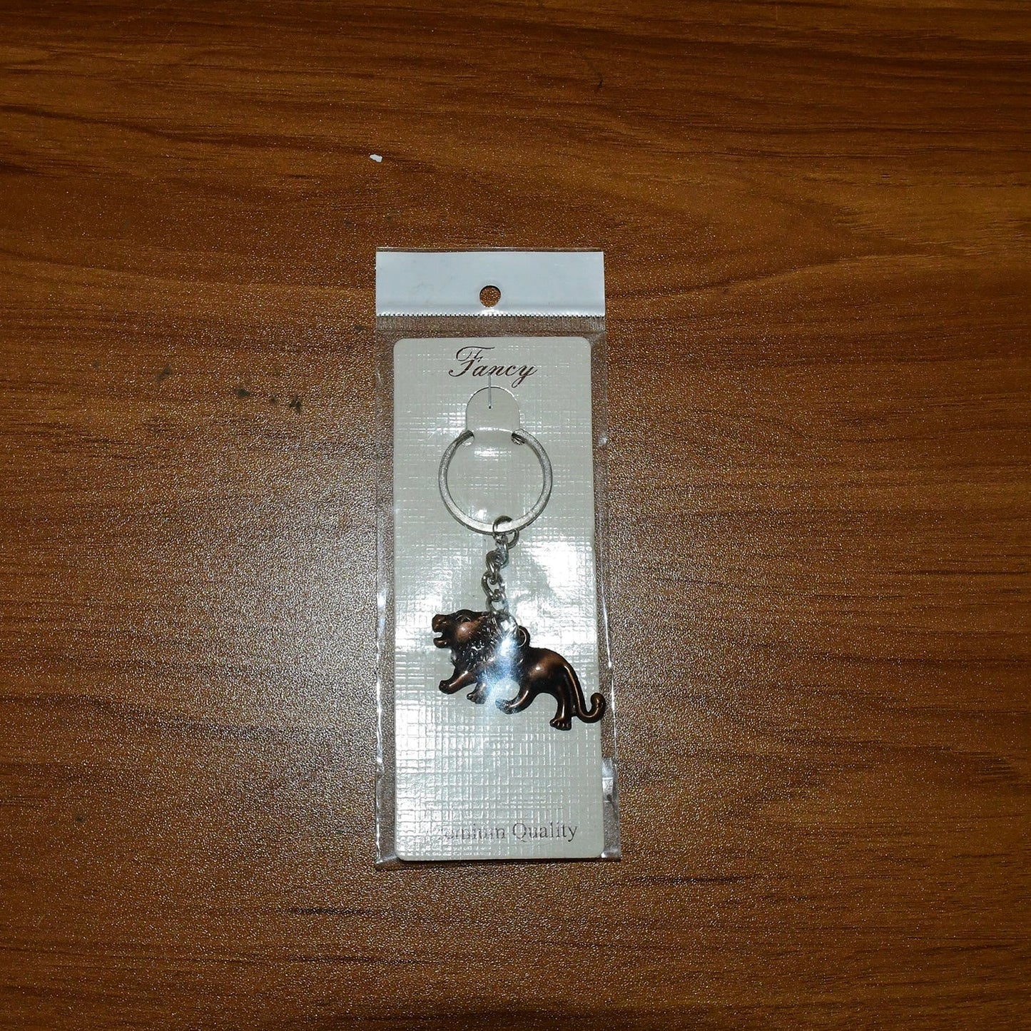 Metal lion keychain attached to car keys for daily use and organization
