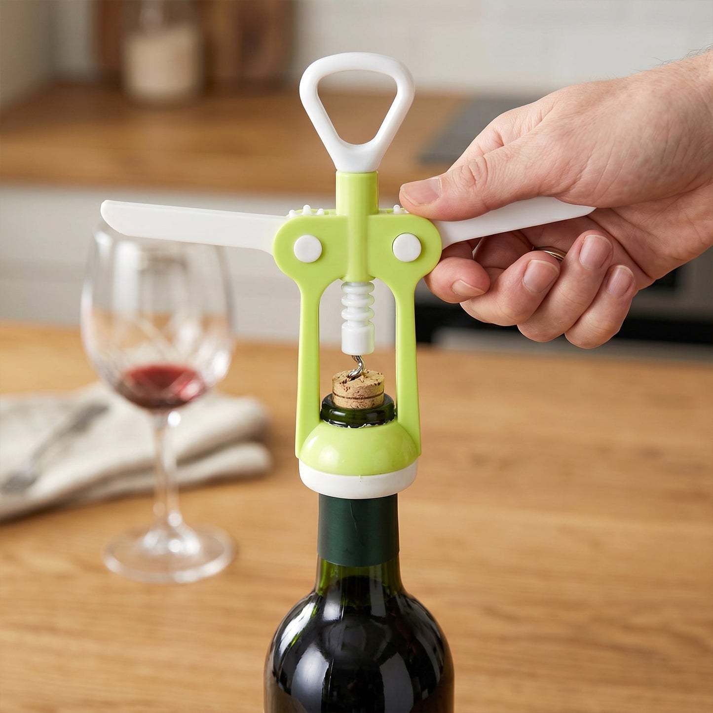 Ergonomic wine bottle opener from the Quickslice Kitchen Tool Set, effortlessly uncorking a bottle.
