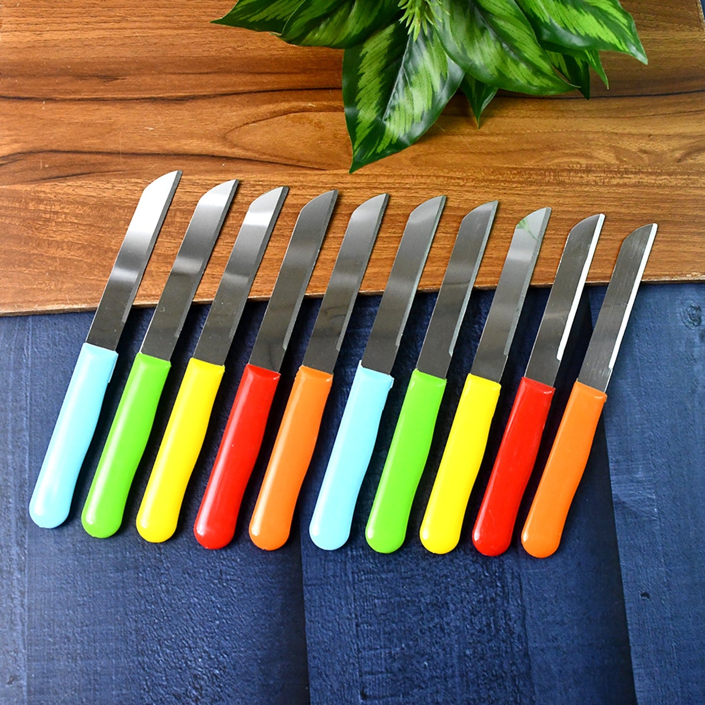 Sharp stainless steel kitchen knives arranged on cutting surface