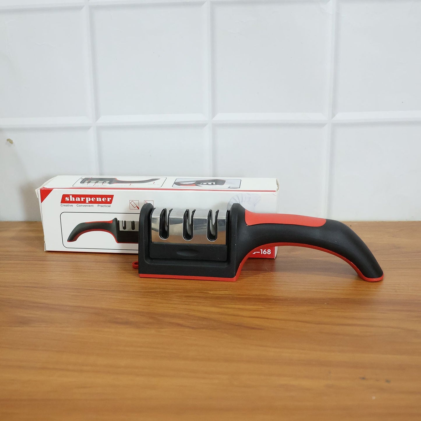 An Indian user demonstrates the manual knife sharpener on a steel blade.