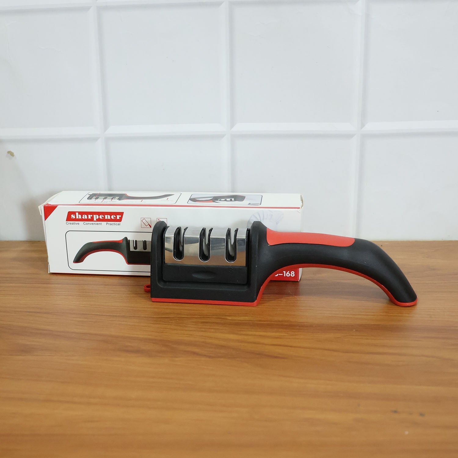 An Indian user demonstrates the manual knife sharpener on a steel blade.