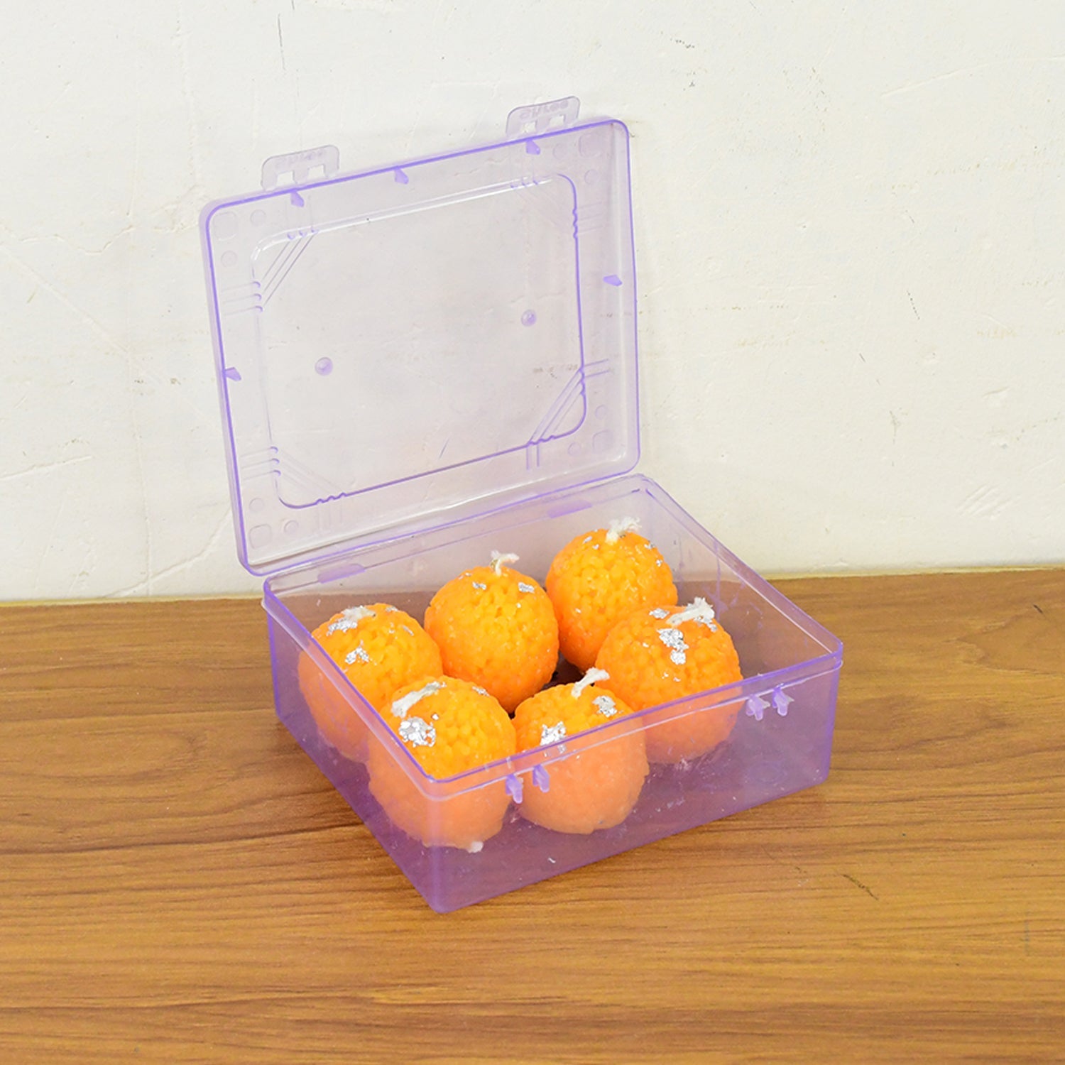 Decorative laddu shaped wax candles displayed as Diwali and festival lighting