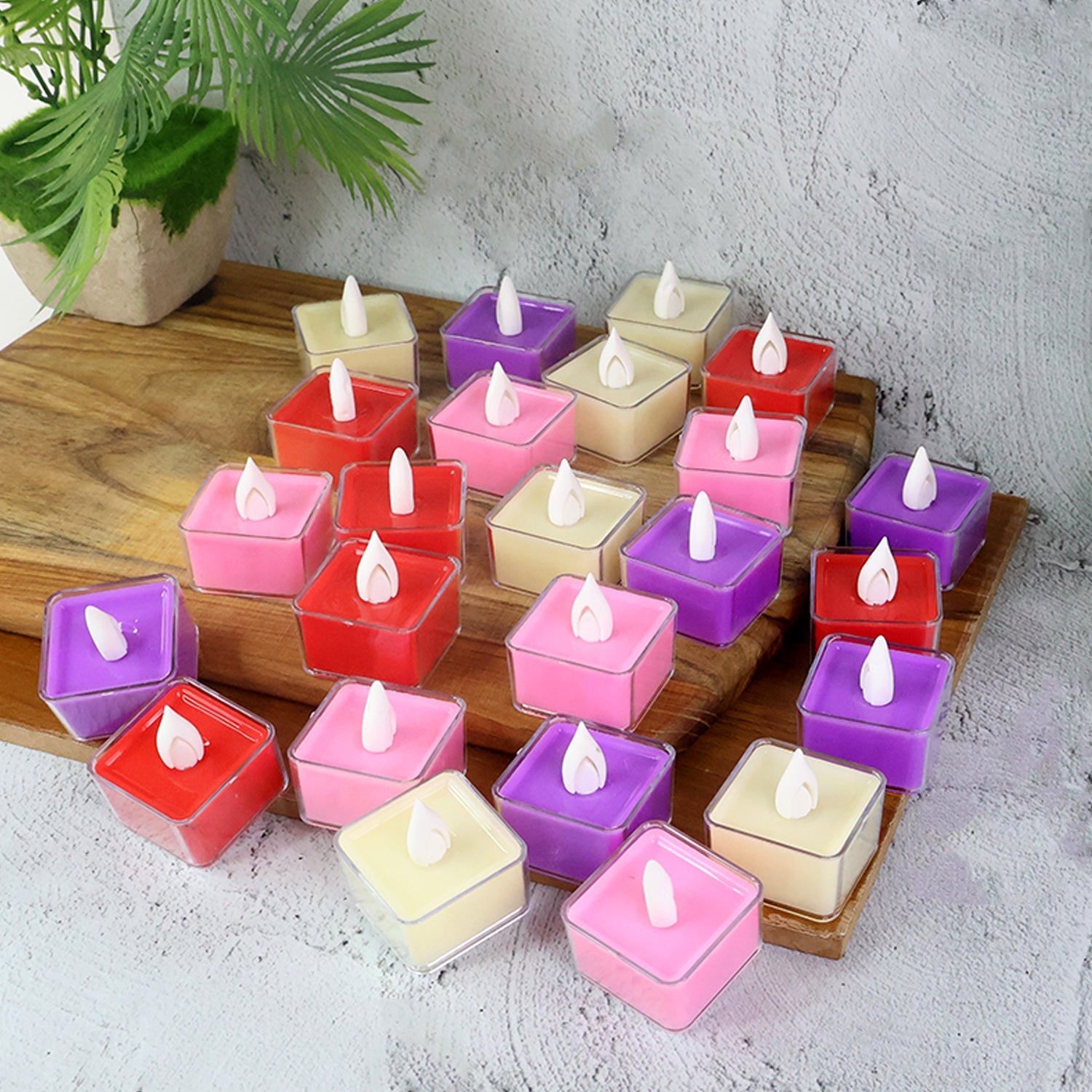 Close-up of red, white, purple, and pink LED tealight candles glowing softly
