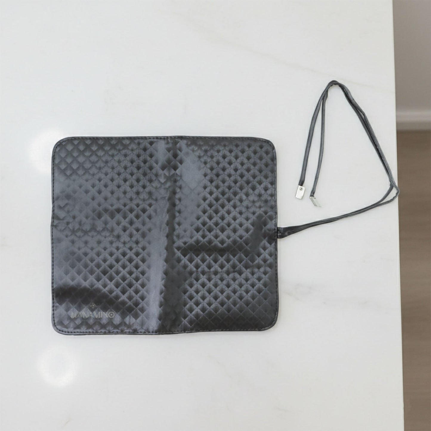 Inside view of foldable makeup brush organizer pouch displaying multiple slots