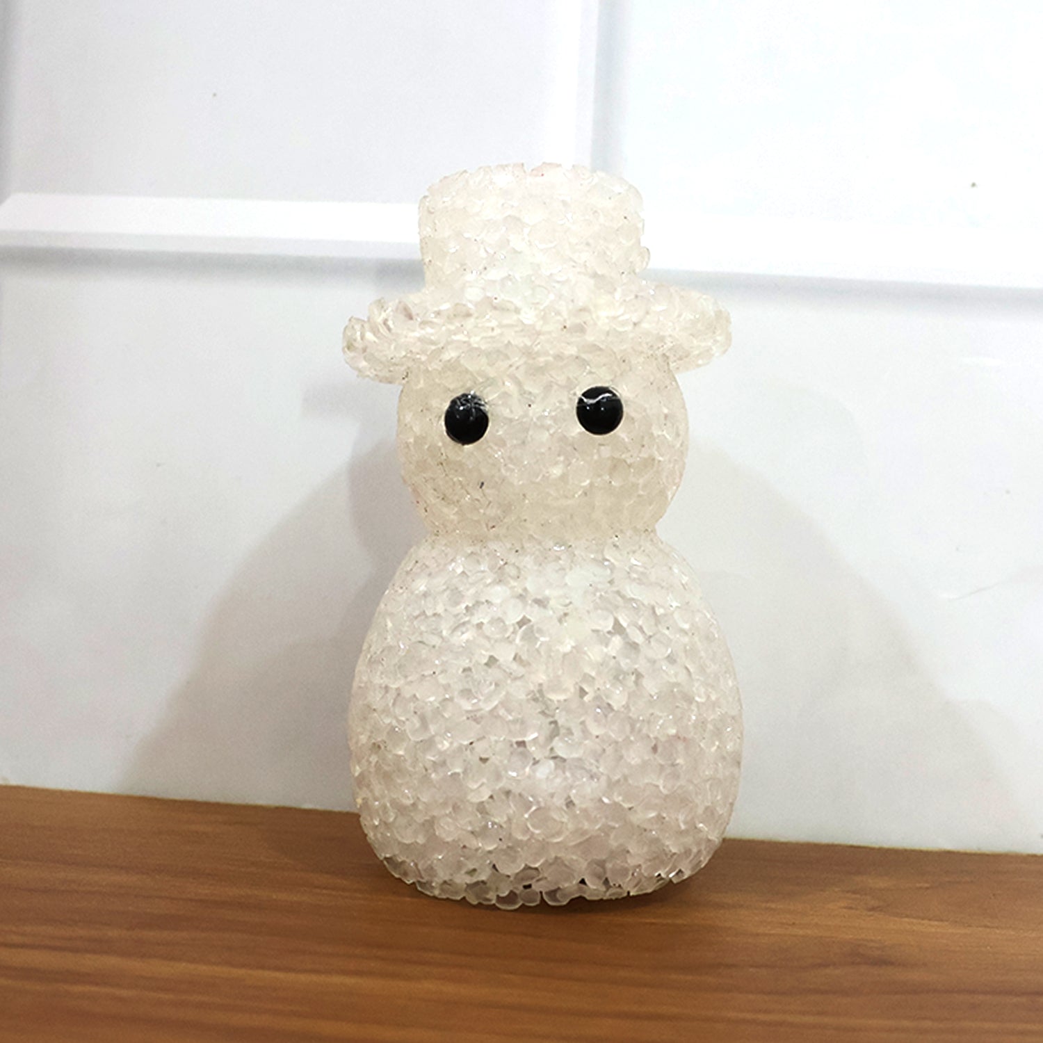 Close-up of snowman LED night lamp with decorative crystal-style finish