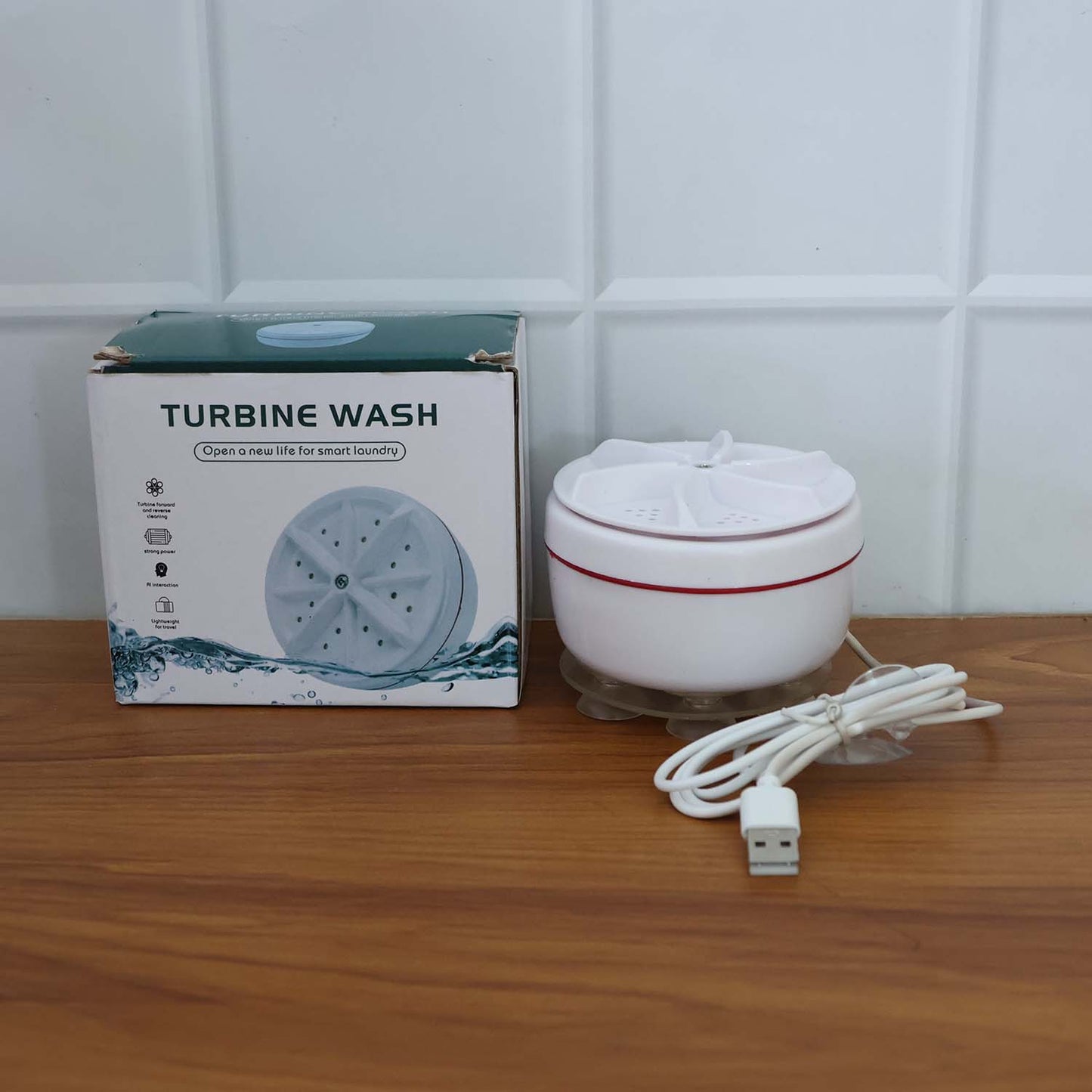 The mini washing machine actively cleaning clothes in a real-life home setting.