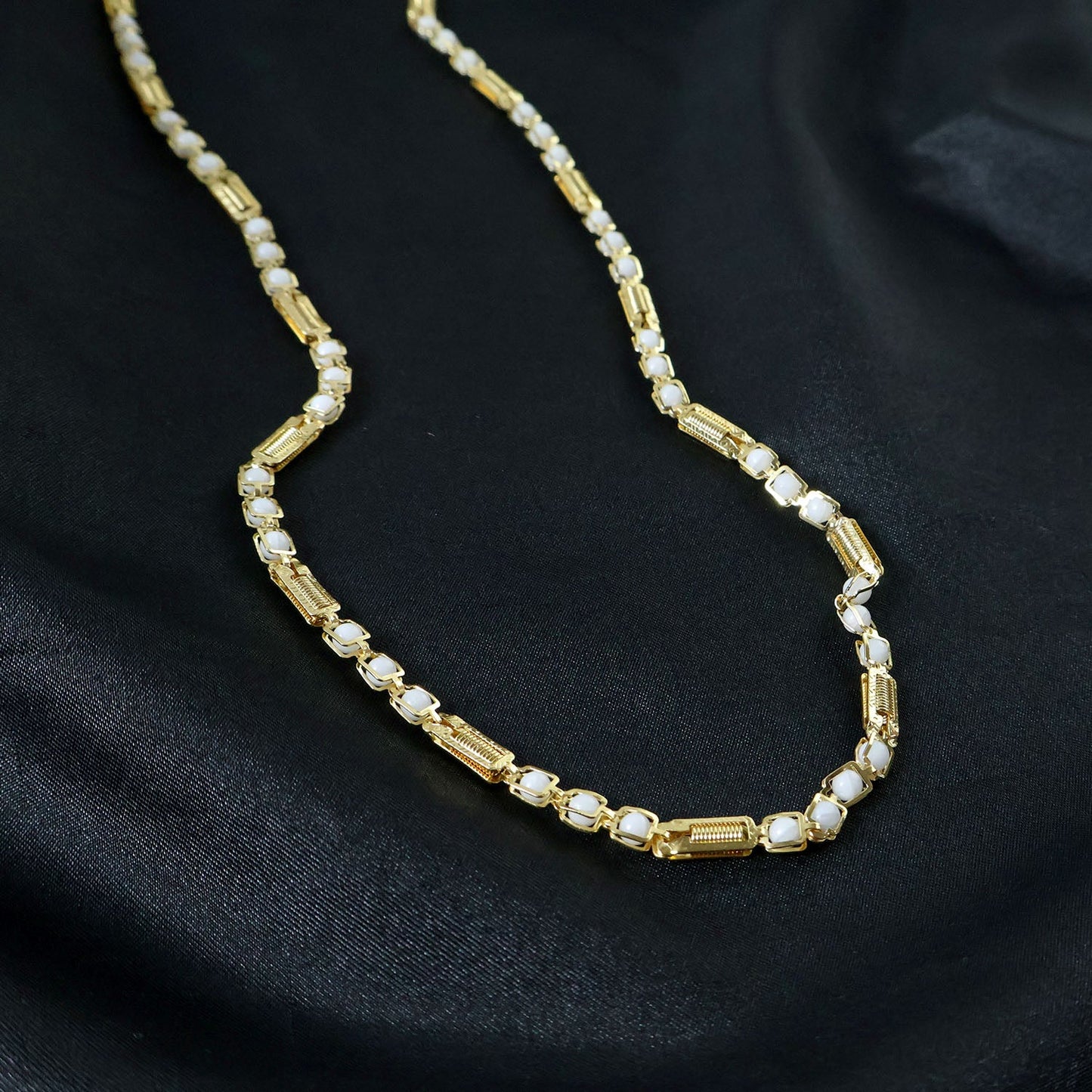 Patterned stone design on gold tone chain necklace
