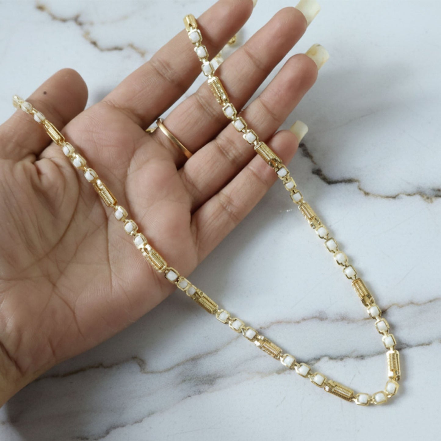 Detailed view of gold tone designer chain necklace features