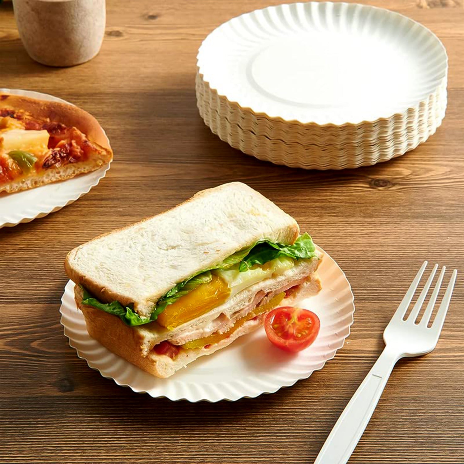 Stack of sturdy compostable paper plates for takeaway