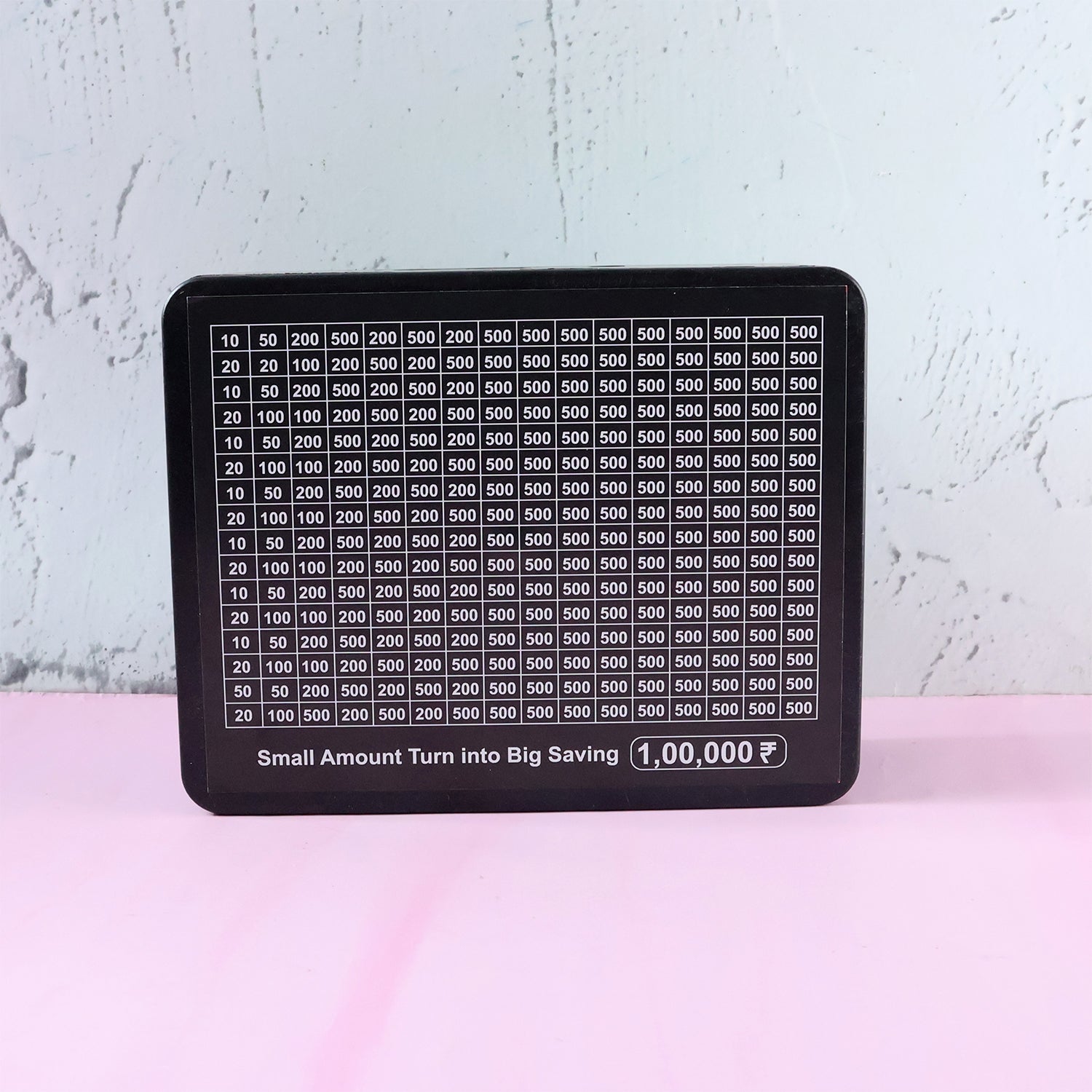 Close-up of money saving challenge board grid and black gel pen