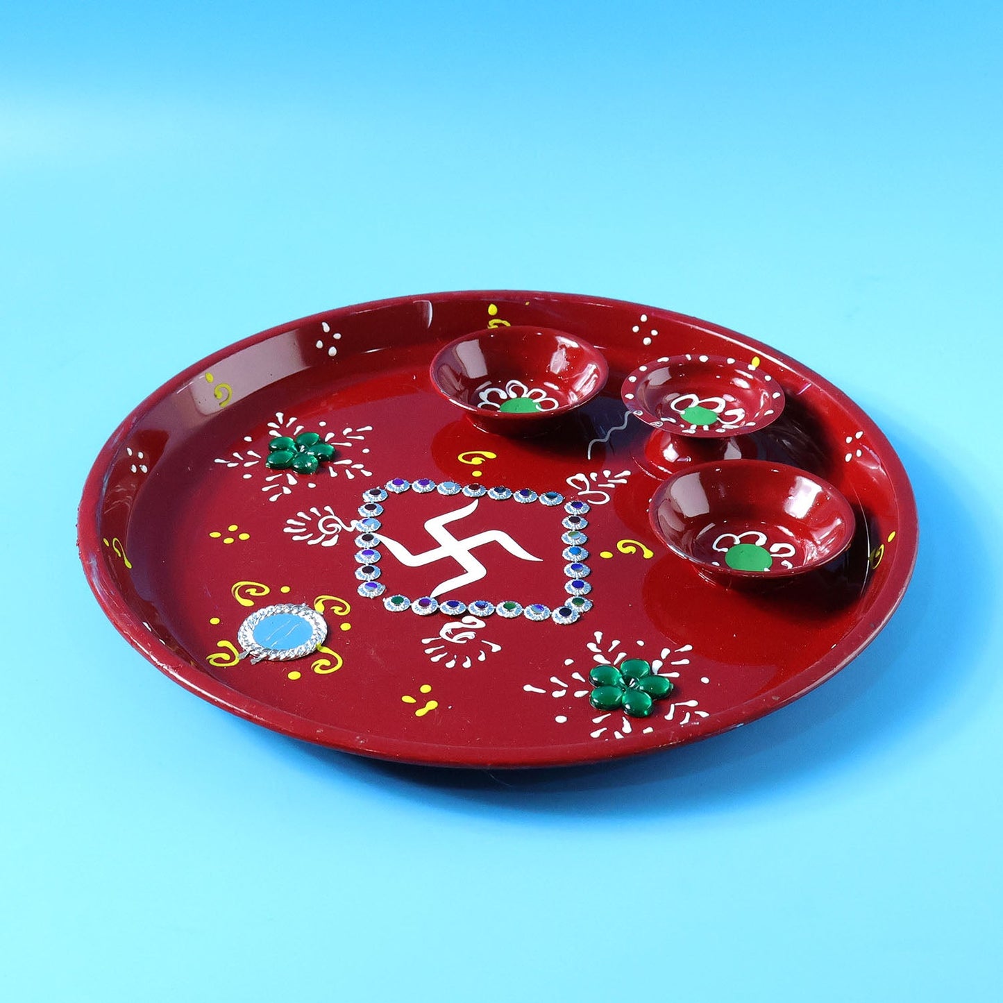 Decorative pooja thali with Ganesha motif used during an Indian religious ceremony