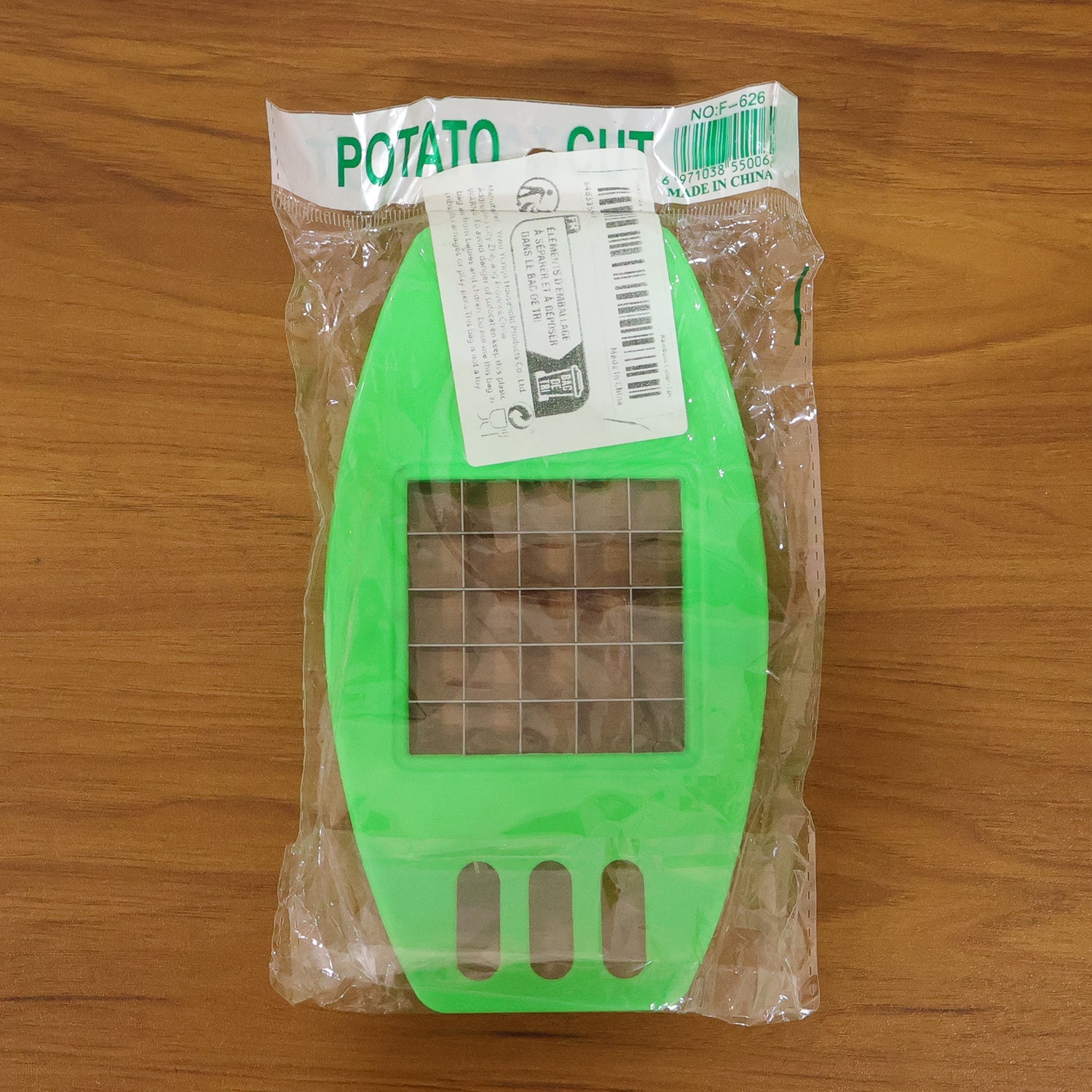 Indo Glow fries cutter effortlessly slicing a sweet potato, demonstrating its versatility.