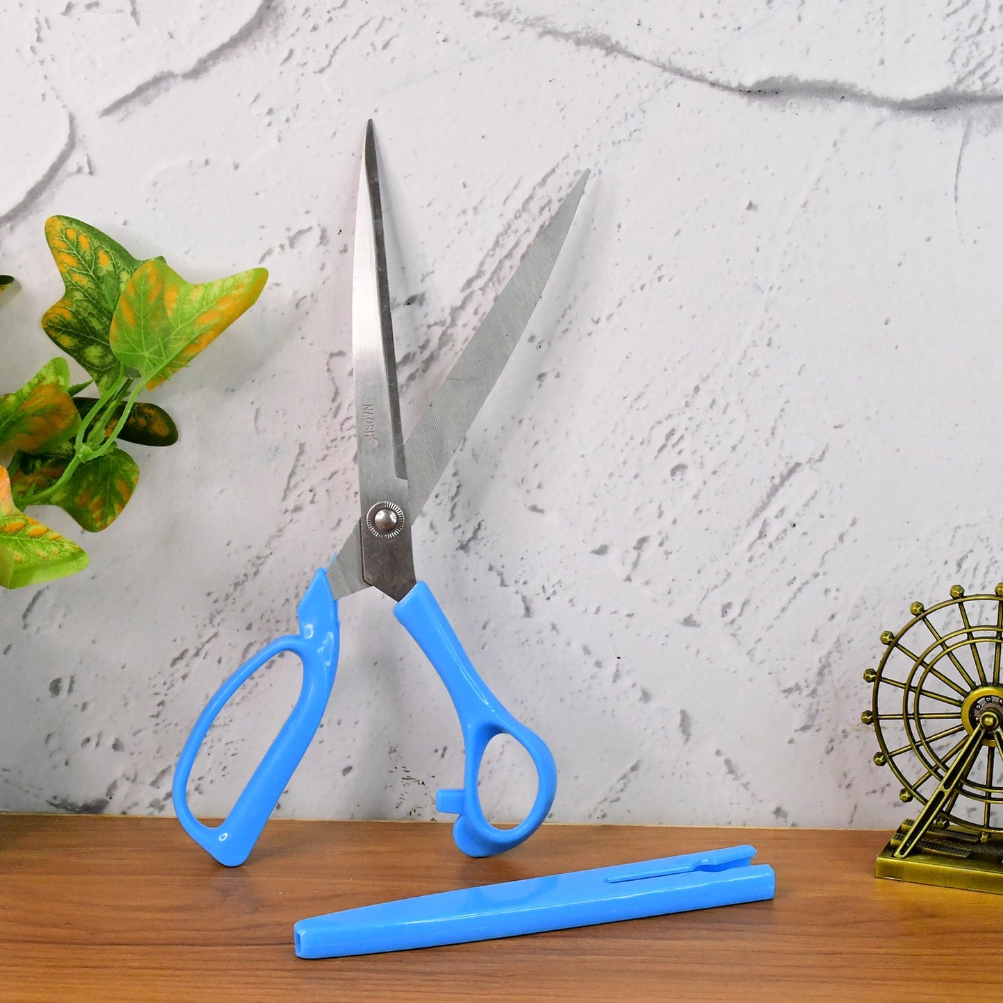Angled side view of the Carbo Titanium scissors, highlighting the ergonomic bent handle.