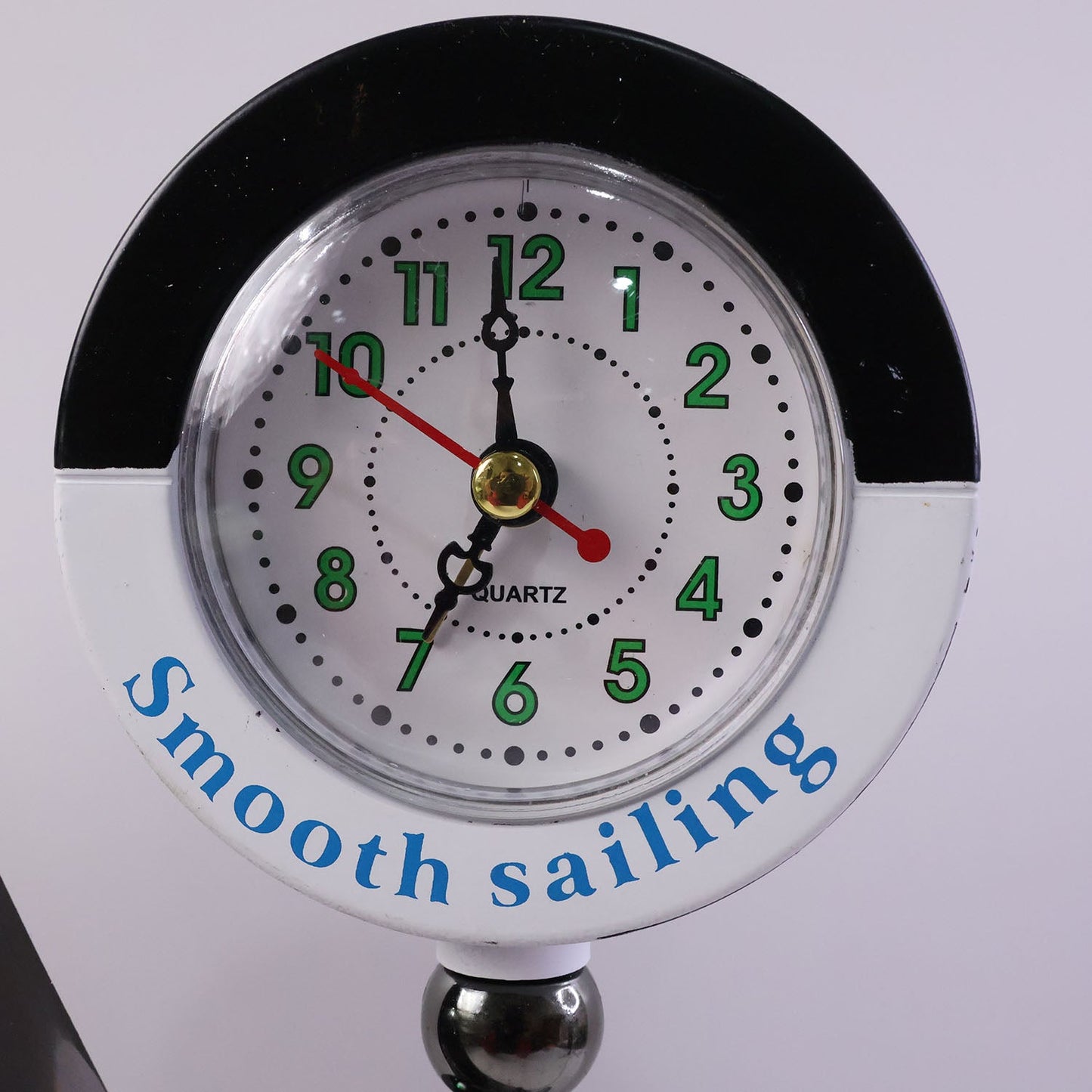 Ship shape clock lamp lit on table showing warm LED ambiance
