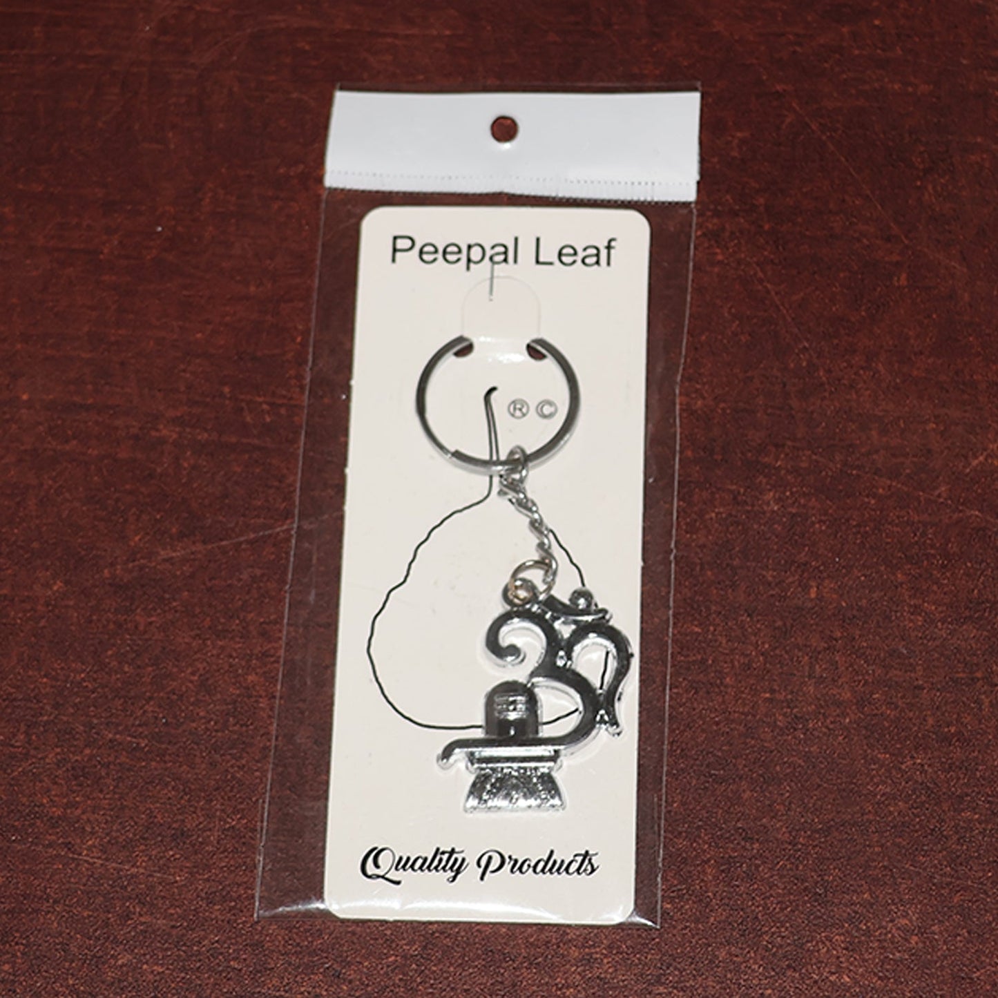 Spiritual metal keychain featuring Om symbol and Shivling icon
