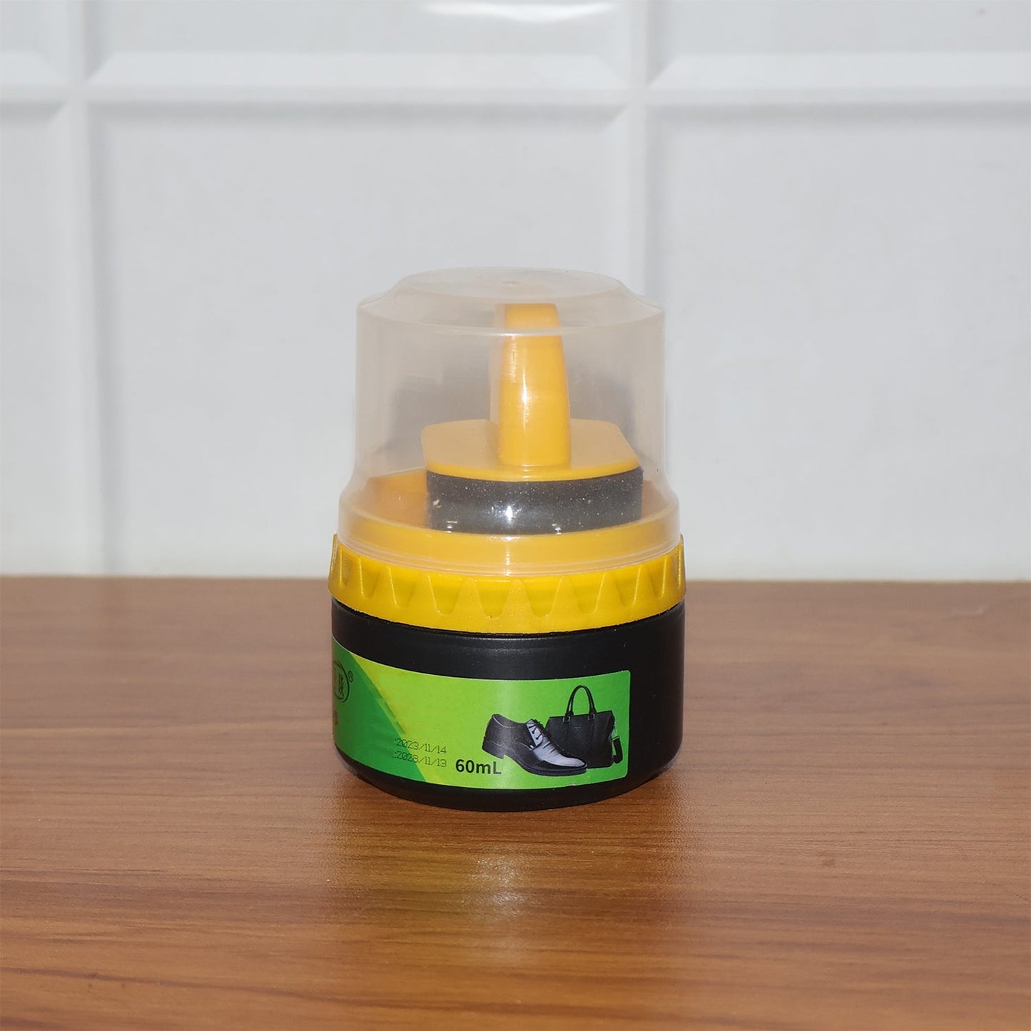 Black shoe polish cream and sponge applicator ready for use