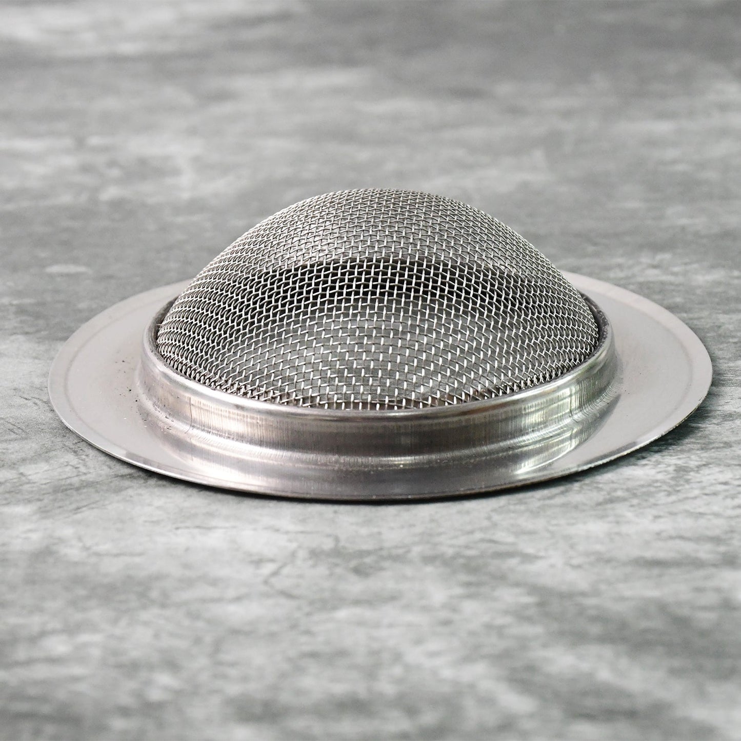 Stainless steel sink strainer trapping food debris during kitchen use