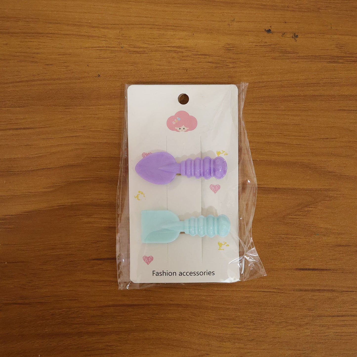 Model wearing mini spade and leaf shaped hair clips