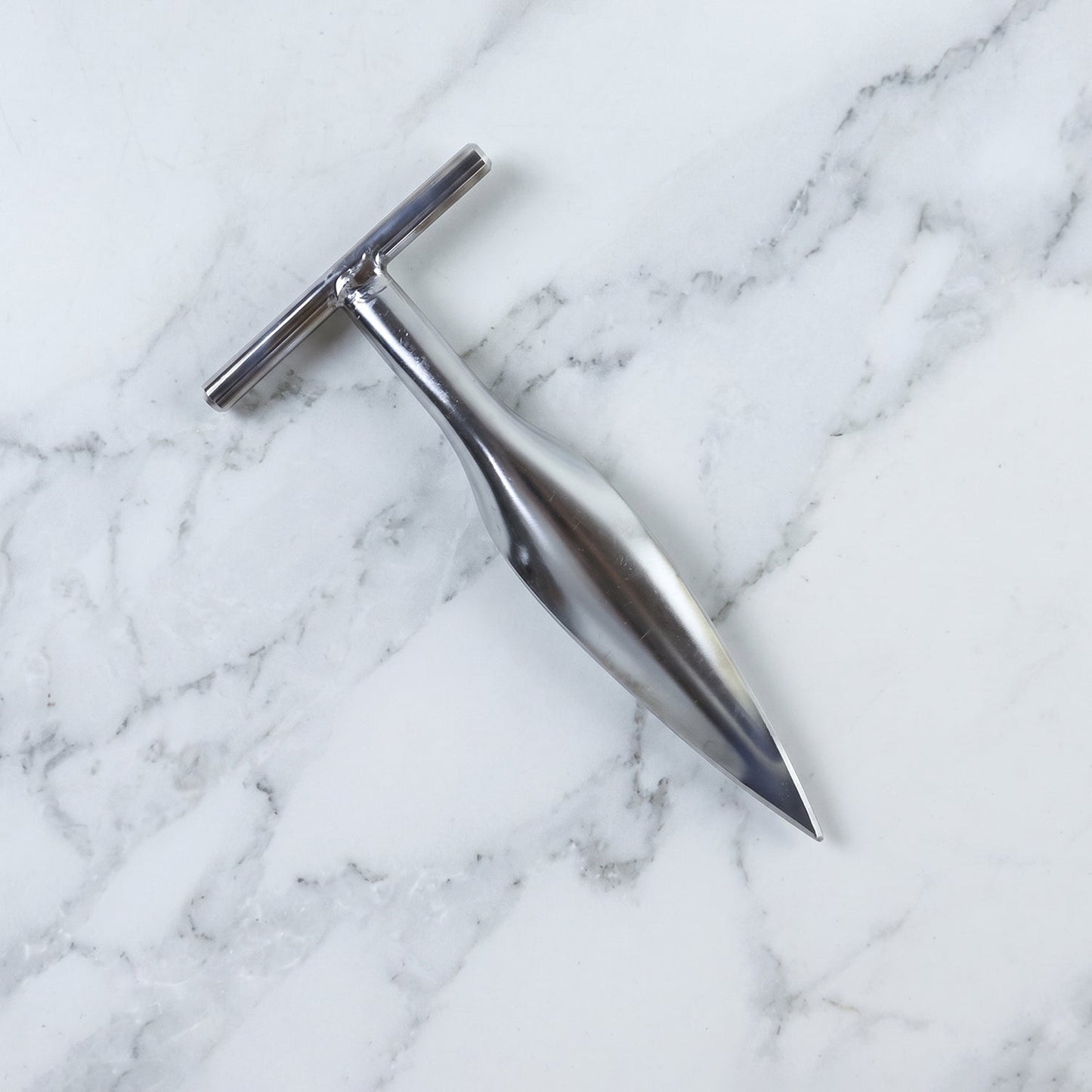 Stainless steel coconut breaker tool set displayed on a white background