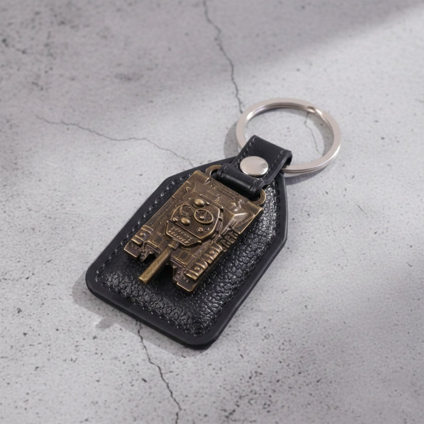 Military tank design keychain attached to bunch of keys with robust metal ring