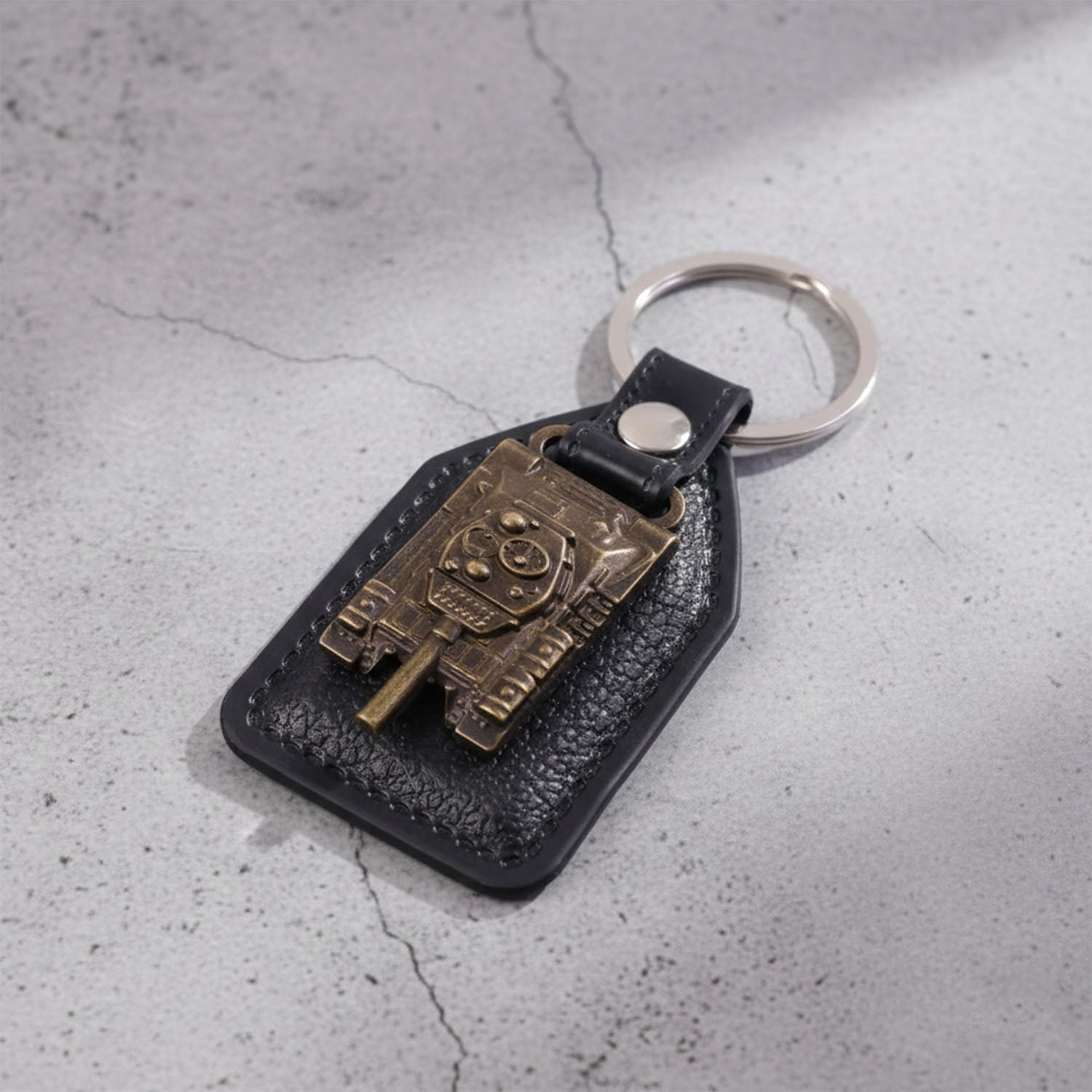 Military tank design keychain attached to bunch of keys with robust metal ring