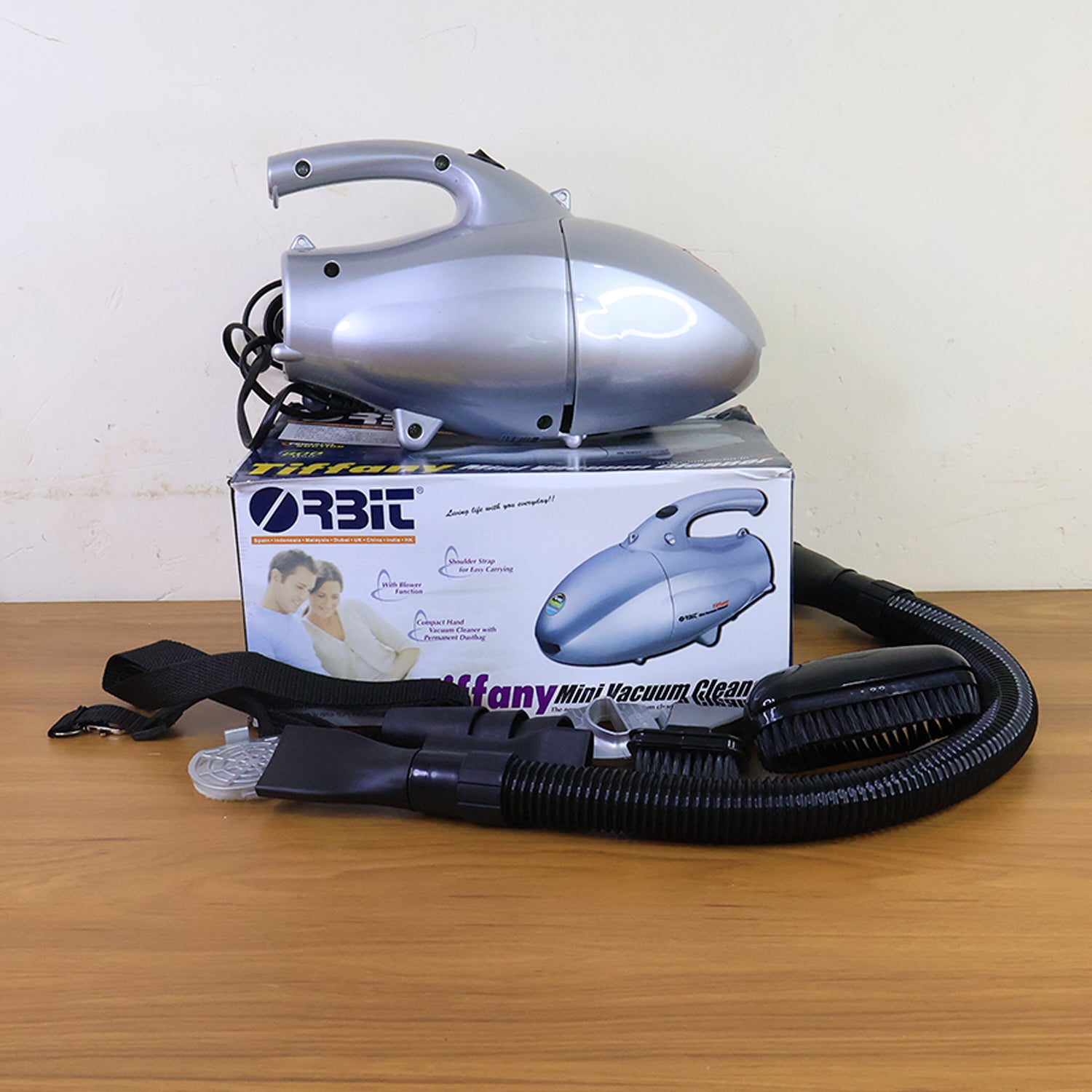 Orbit mini vacuum cleaner product display with multiple attachments laid out
