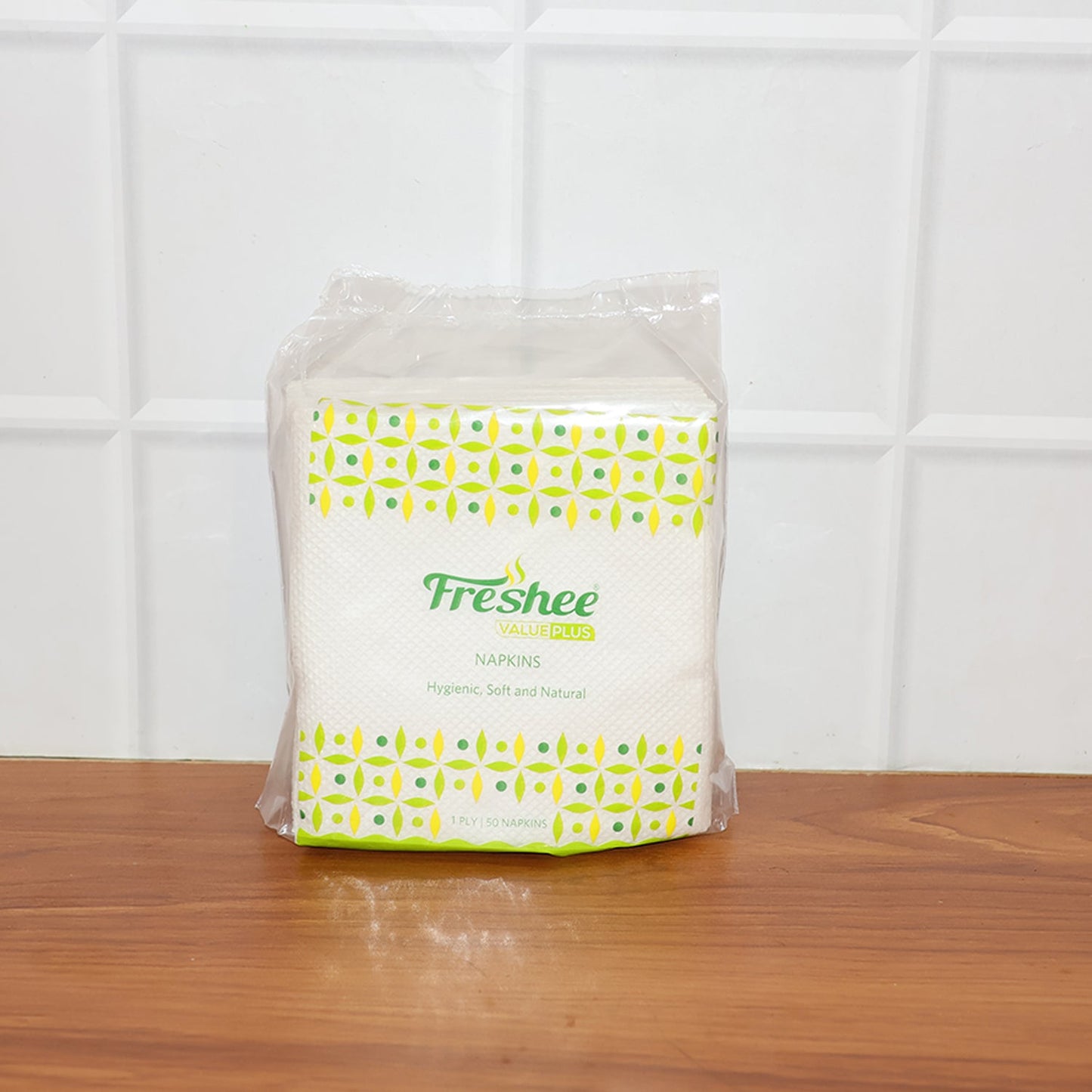 Single disposable paper napkin featuring embossed absorbent texture